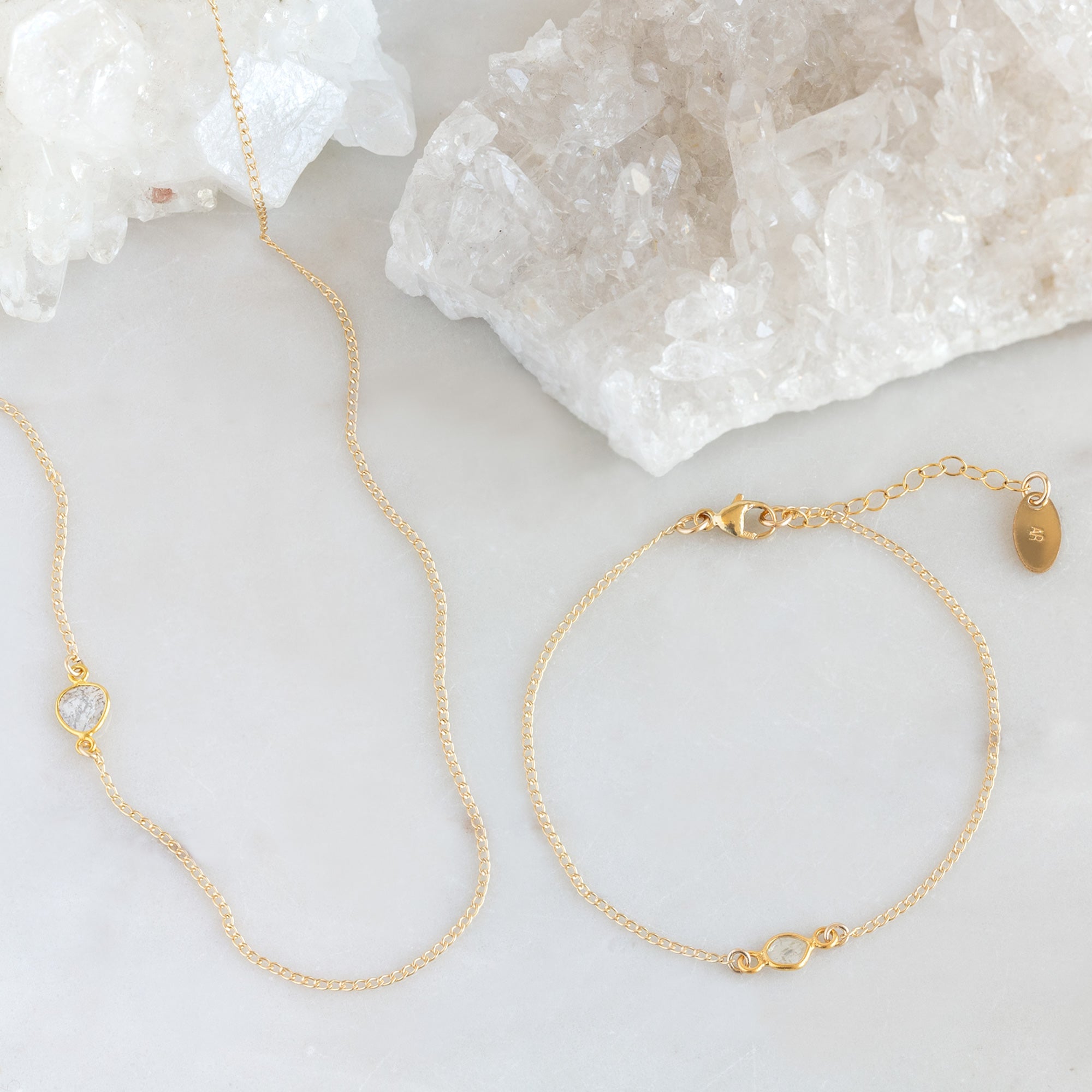 The Salt and Pepper Diamond Slice Bracelet and Necklace in Yellow Gold Filled on White Marble