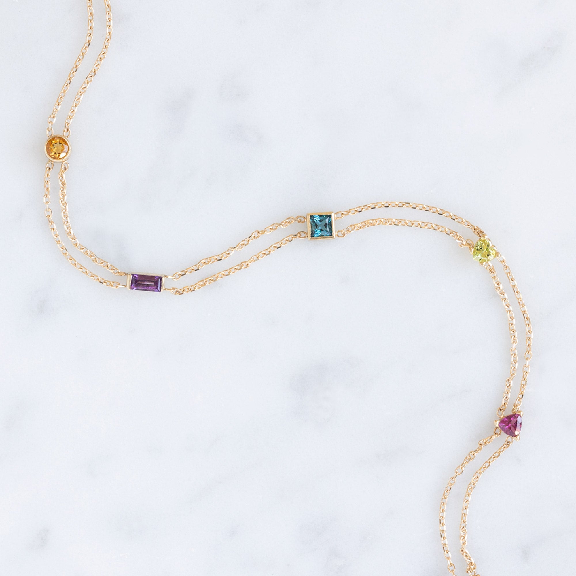 The Candy Gemstone Bracelet in 10K Yellow Gold on White Marble