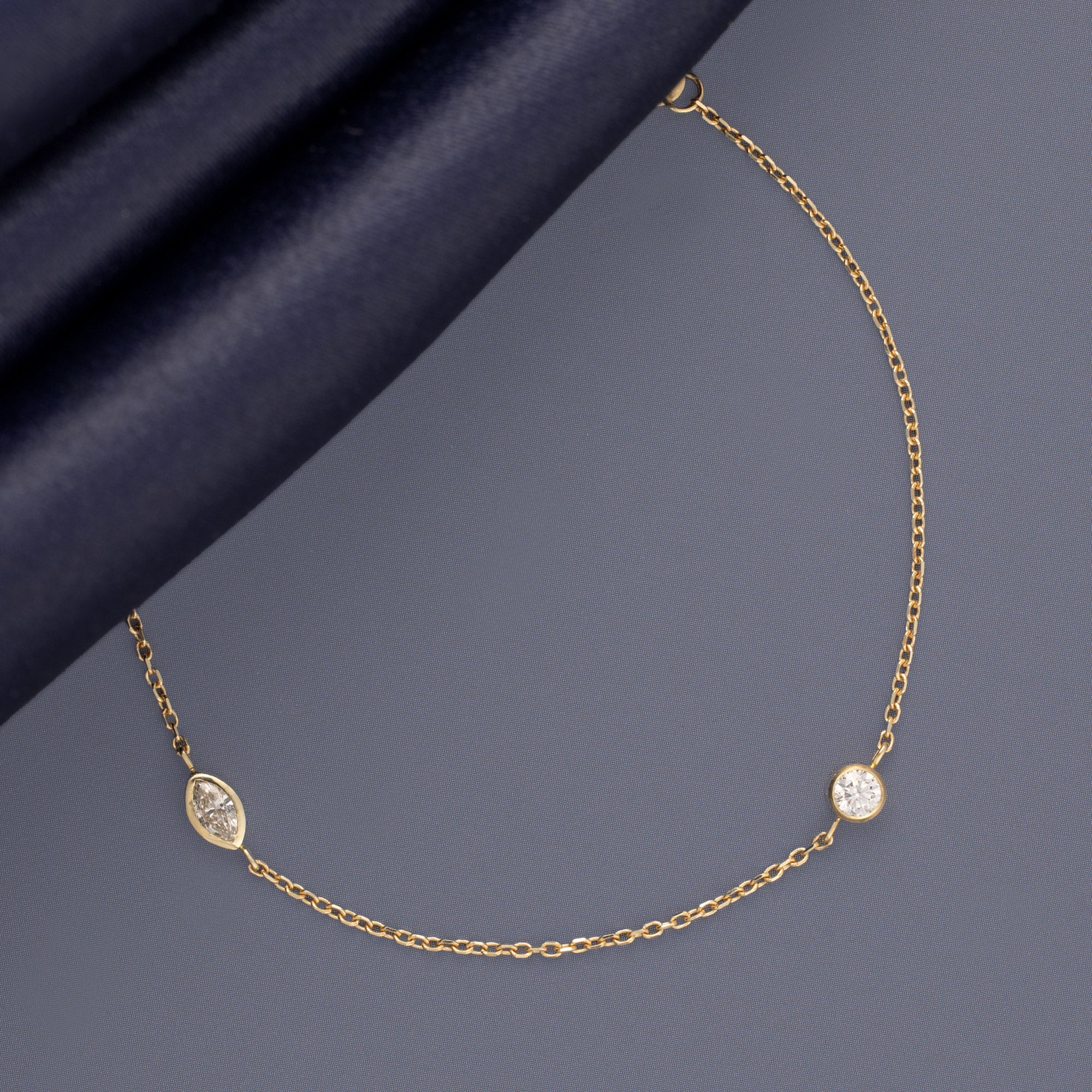 Marquis Diamond Chain Bracelet in 10K Yellow Gold on Muted Blue Background