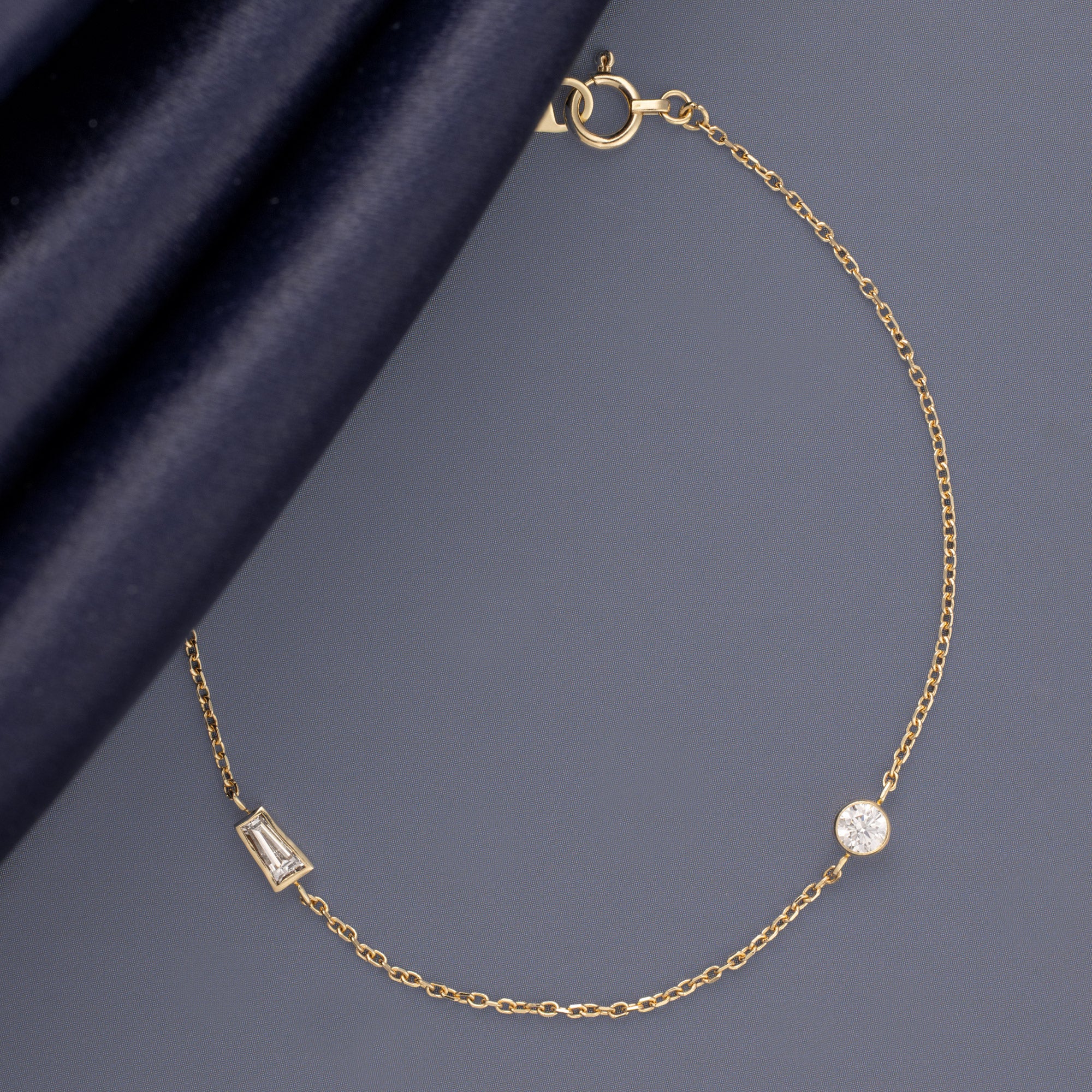 Baguette Diamond Chain Bracelet in 10K Yellow Gold on Muted Blue Background