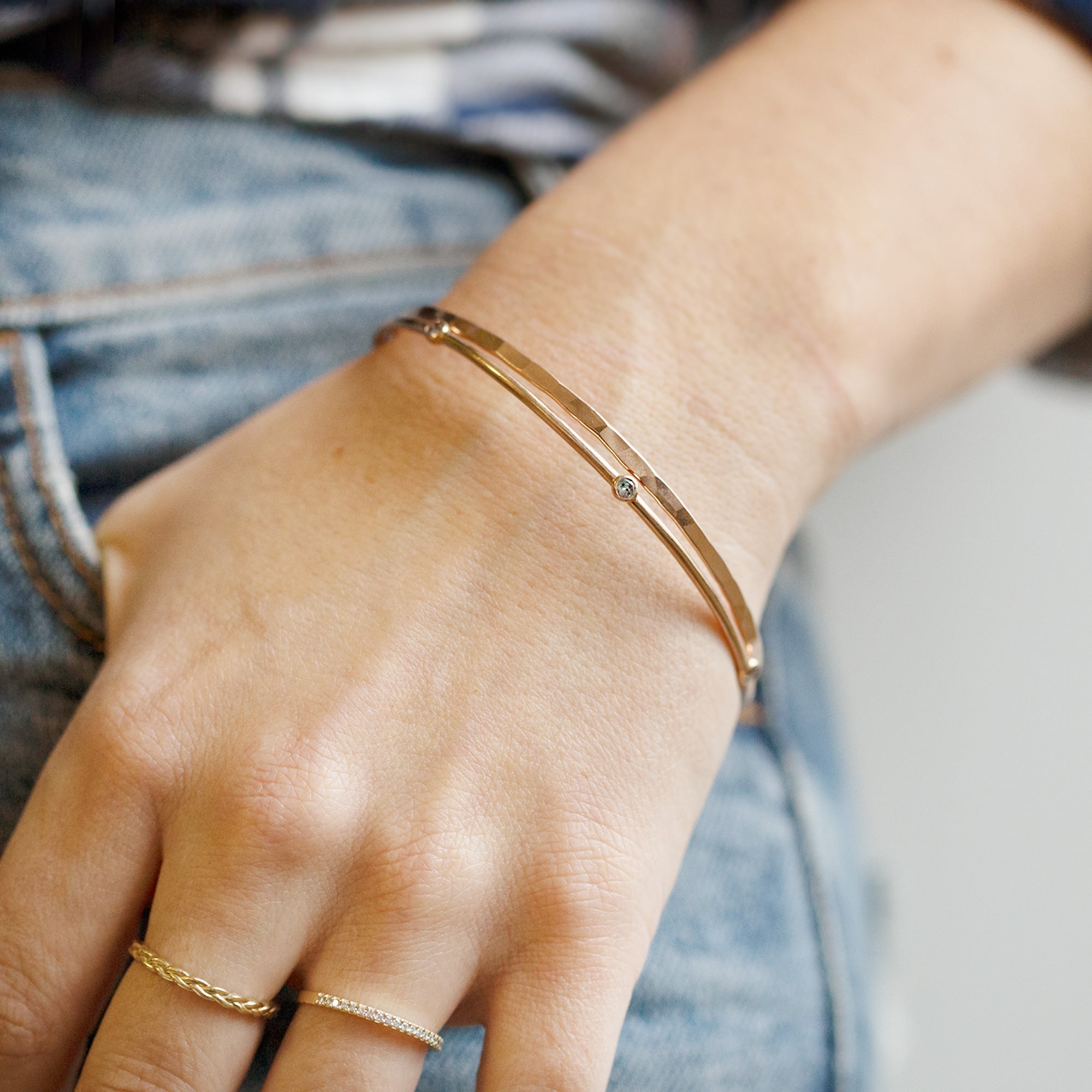 The Salt and Pepper Diamond Constellation Bangle in 14K Yellow Gold Stacked on Model