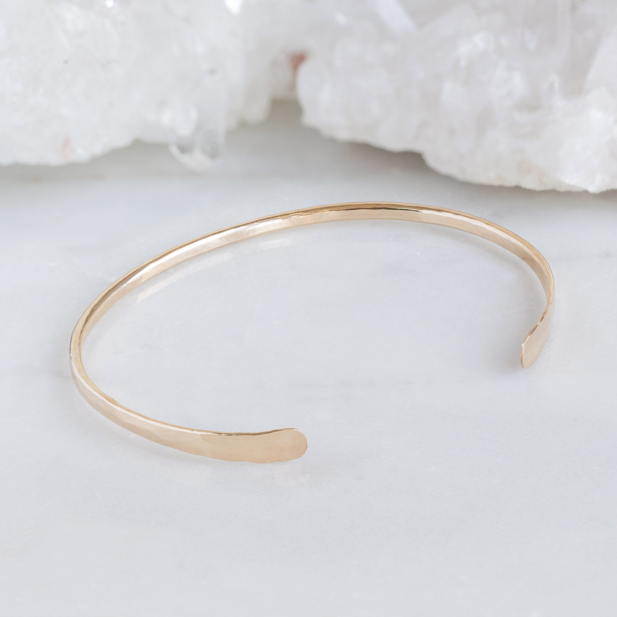 The Hammered Open Cuff Bracelet in Yellow Gold Filled on White Marble