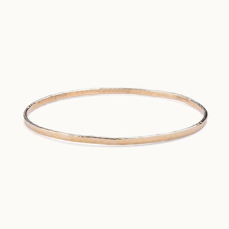 The Hammered Stacking Bangle in Yellow Gold Filled on White Background