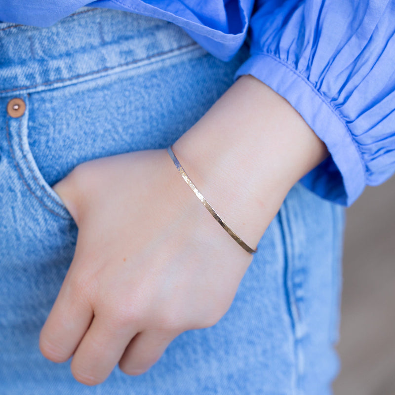 The Hammered Stacking Bangle in Yellow Gold Filled on Model