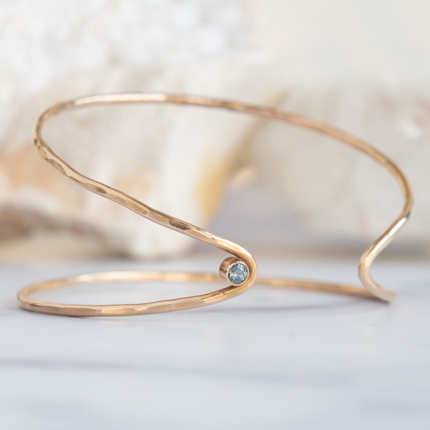 The Sapphire Arrow Cuff Bracelet in Yellow Gold Filled on White Marble