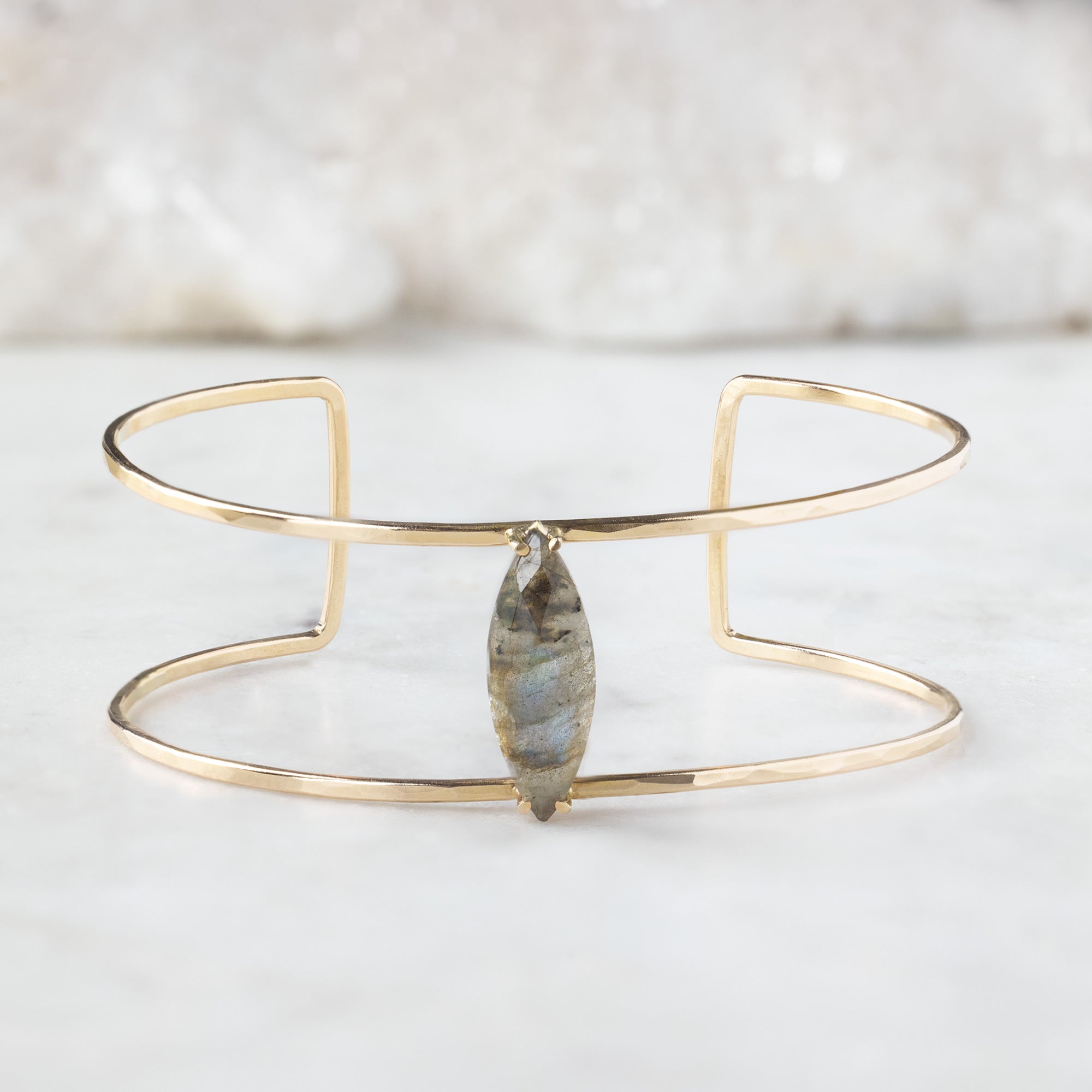 The Labradorite Cage Cuff Bracelet in Yellow Gold Filled on White Marble Tile