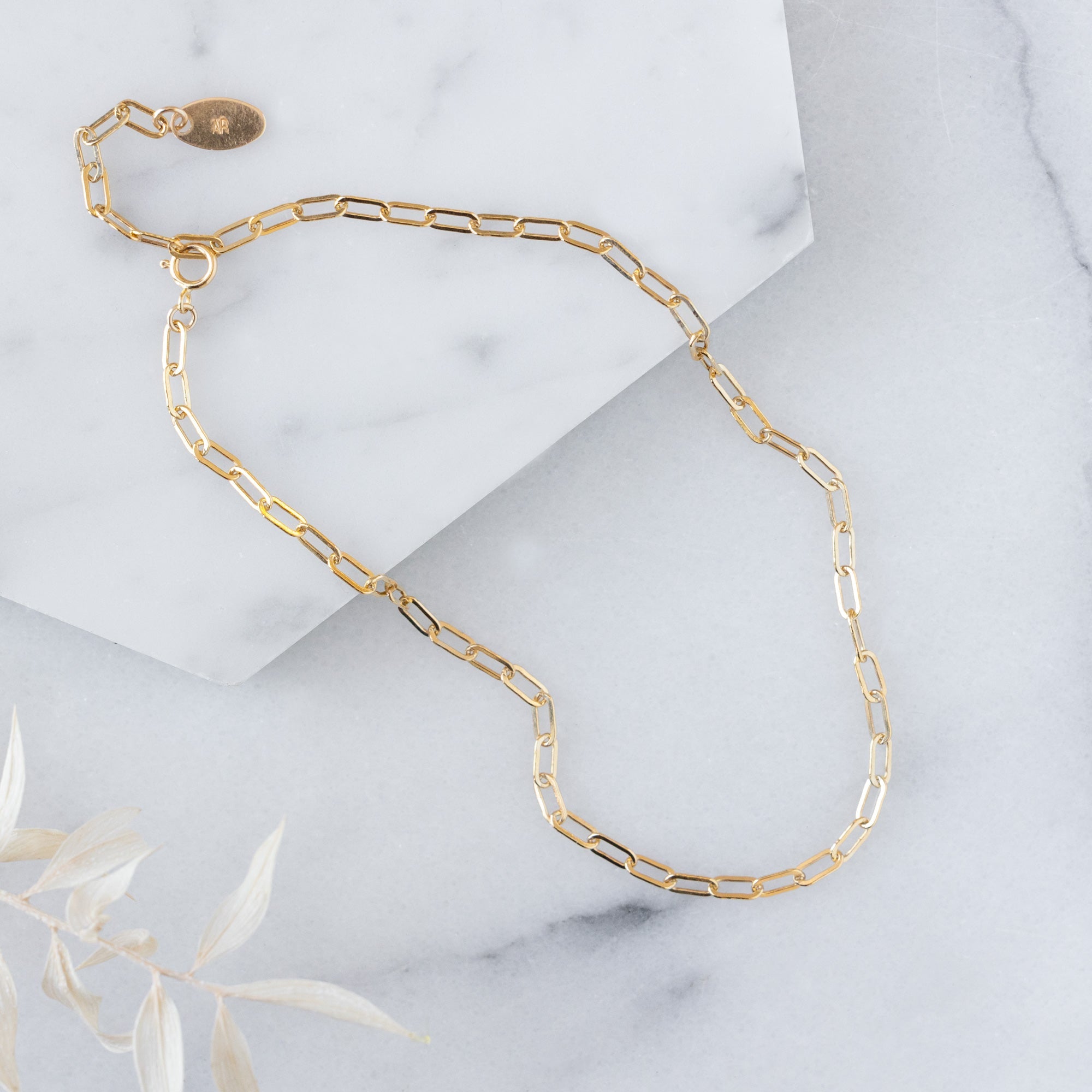 The Drawn Cable Chain Anklet in Yellow Gold Filled on White Marble