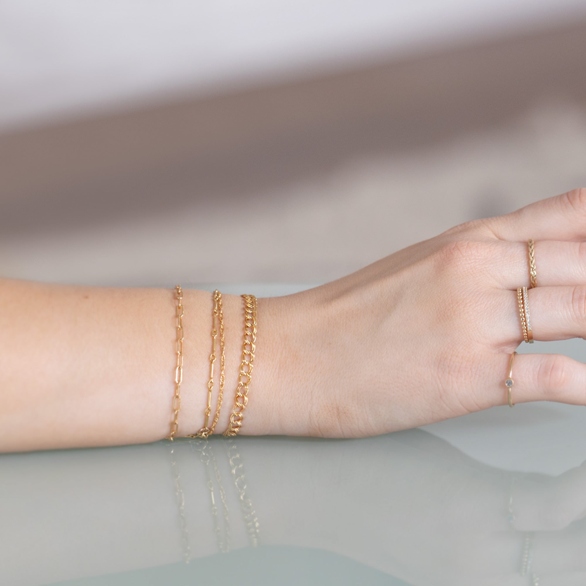 The Bar Chain Bracelet in Yellow Gold Filled Stacked on Model