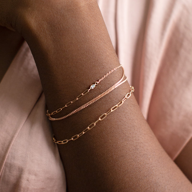 The 4-in-1 Cable Chain Bracelet in Rose Gold Filled Stacked on Model