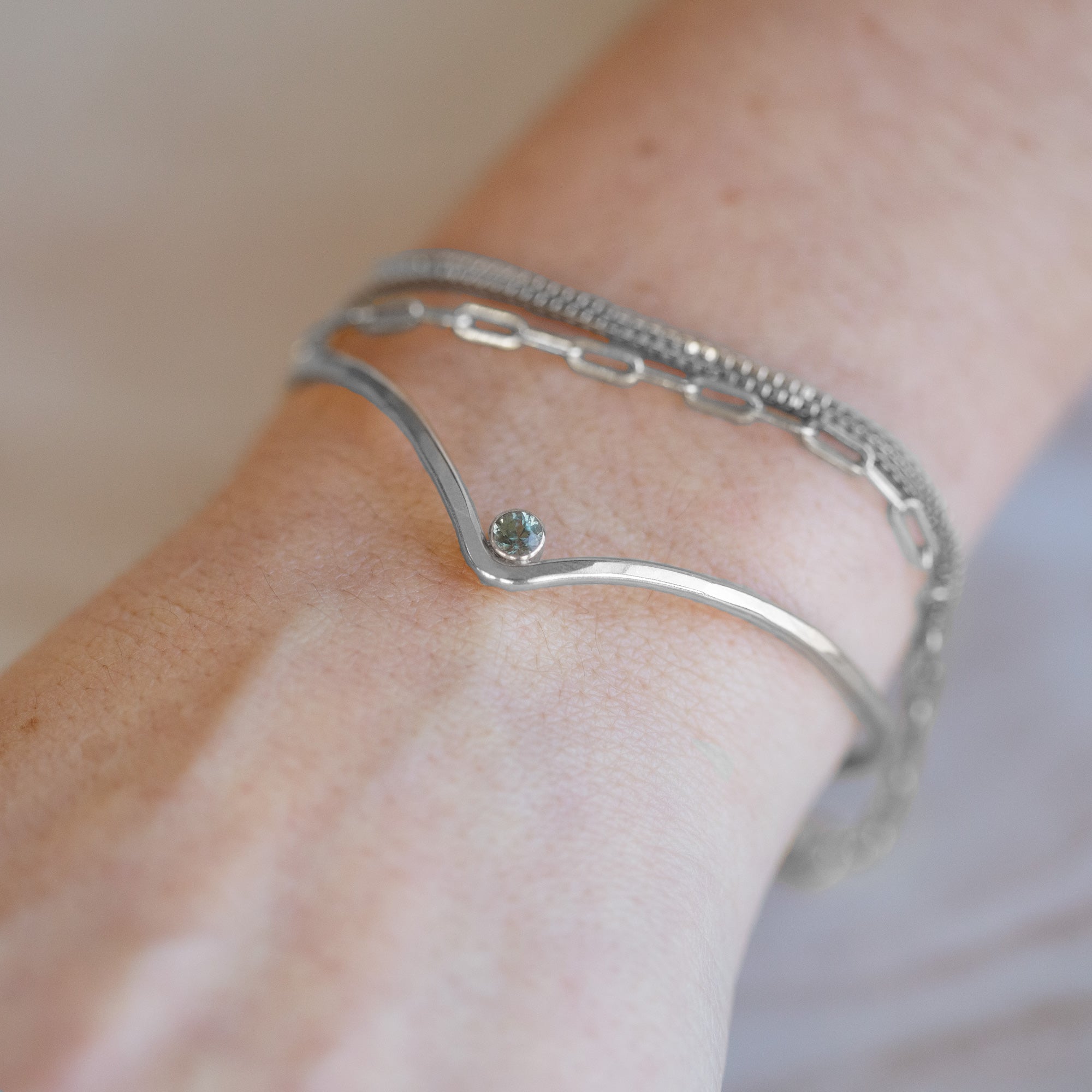 The Montana Sapphire Peak Cuff Bracelet in Sterling Silver Stacked on Model