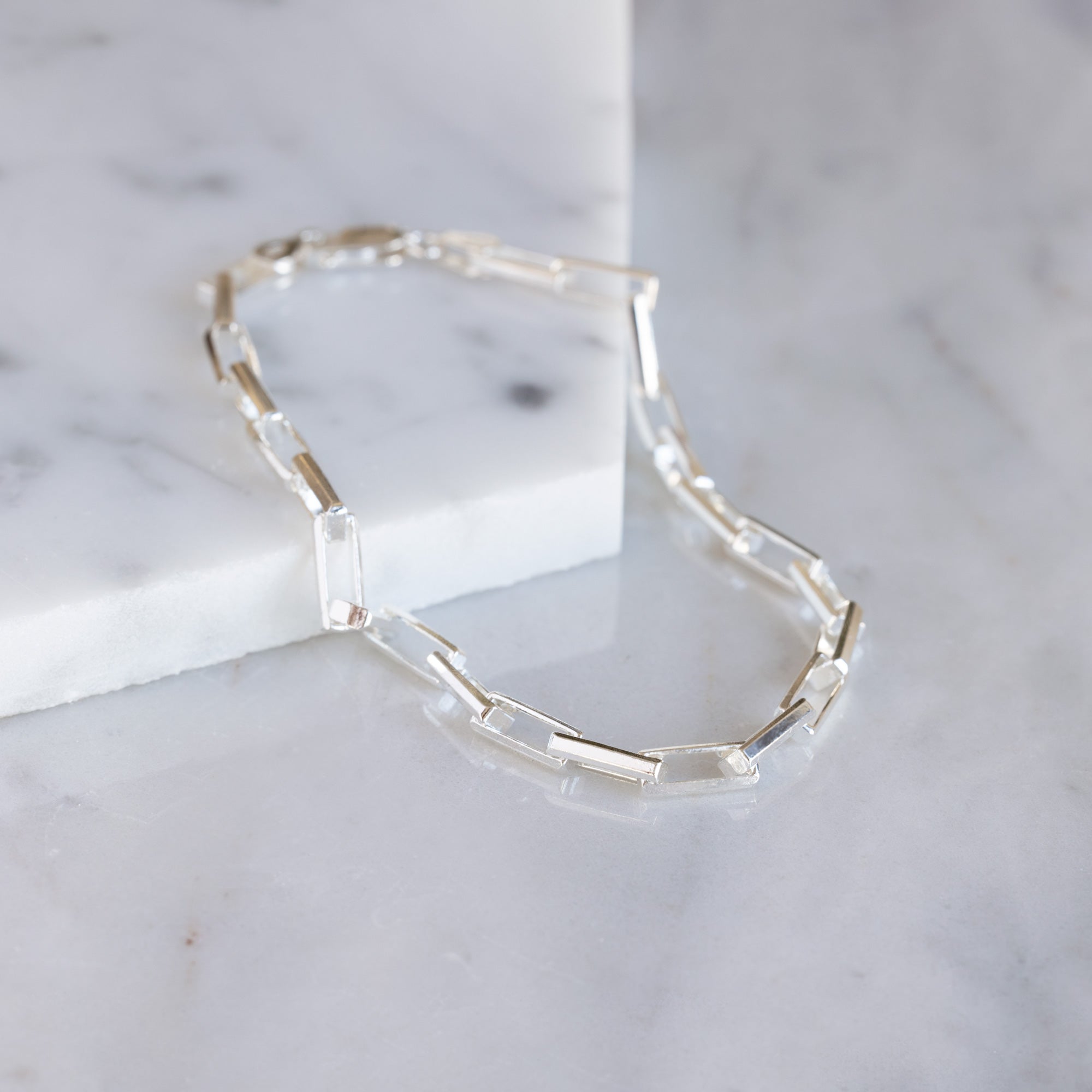 The Men's Drawn Cable Chain Bracelet in Sterling Silver on White Marble