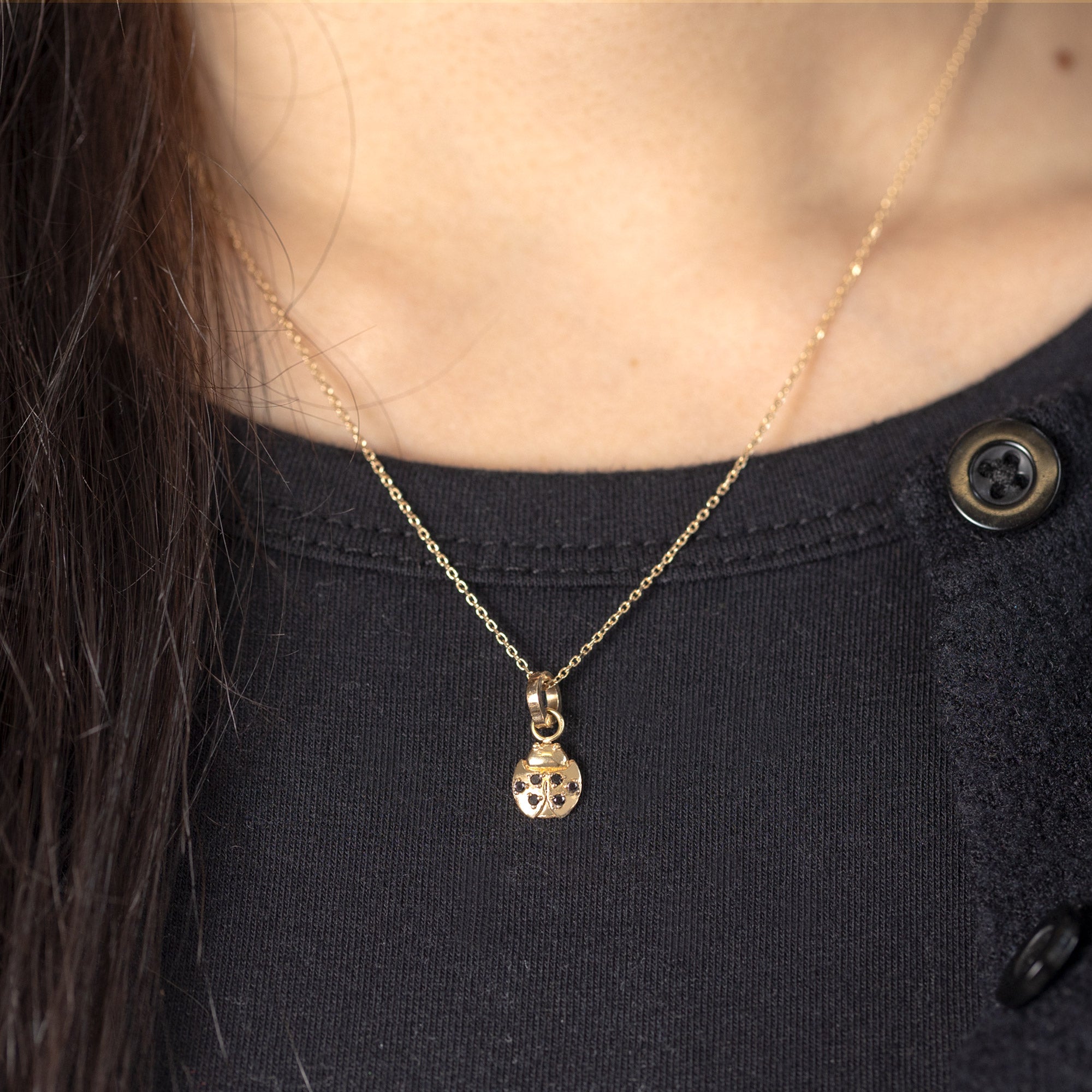 The Ladybug Charm in 10K Yellow Gold  on Diamond Cut Cable Chain on Model