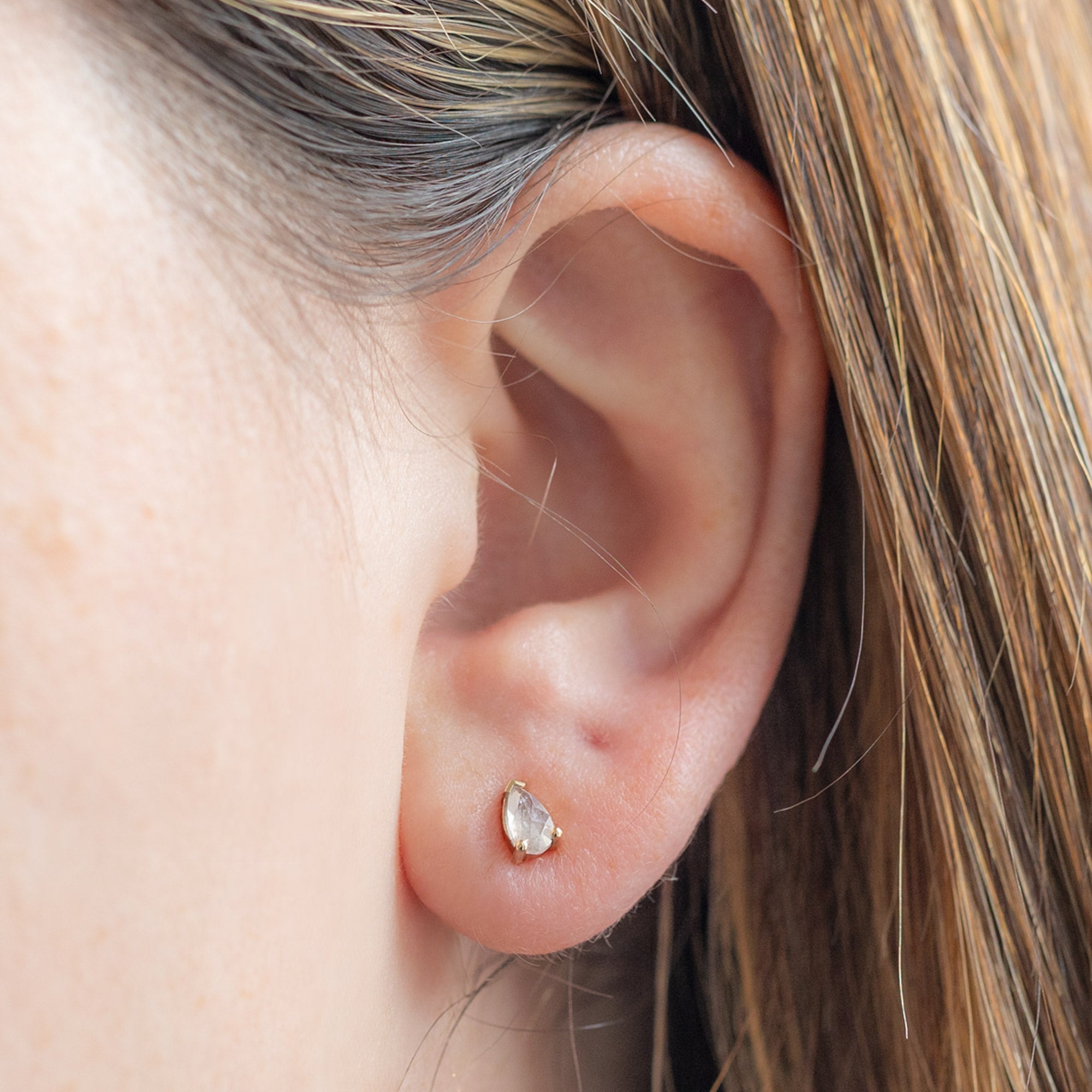 The Opalescent Icy White Diamond Stud Earrings in 10K Yellow Gold on Model