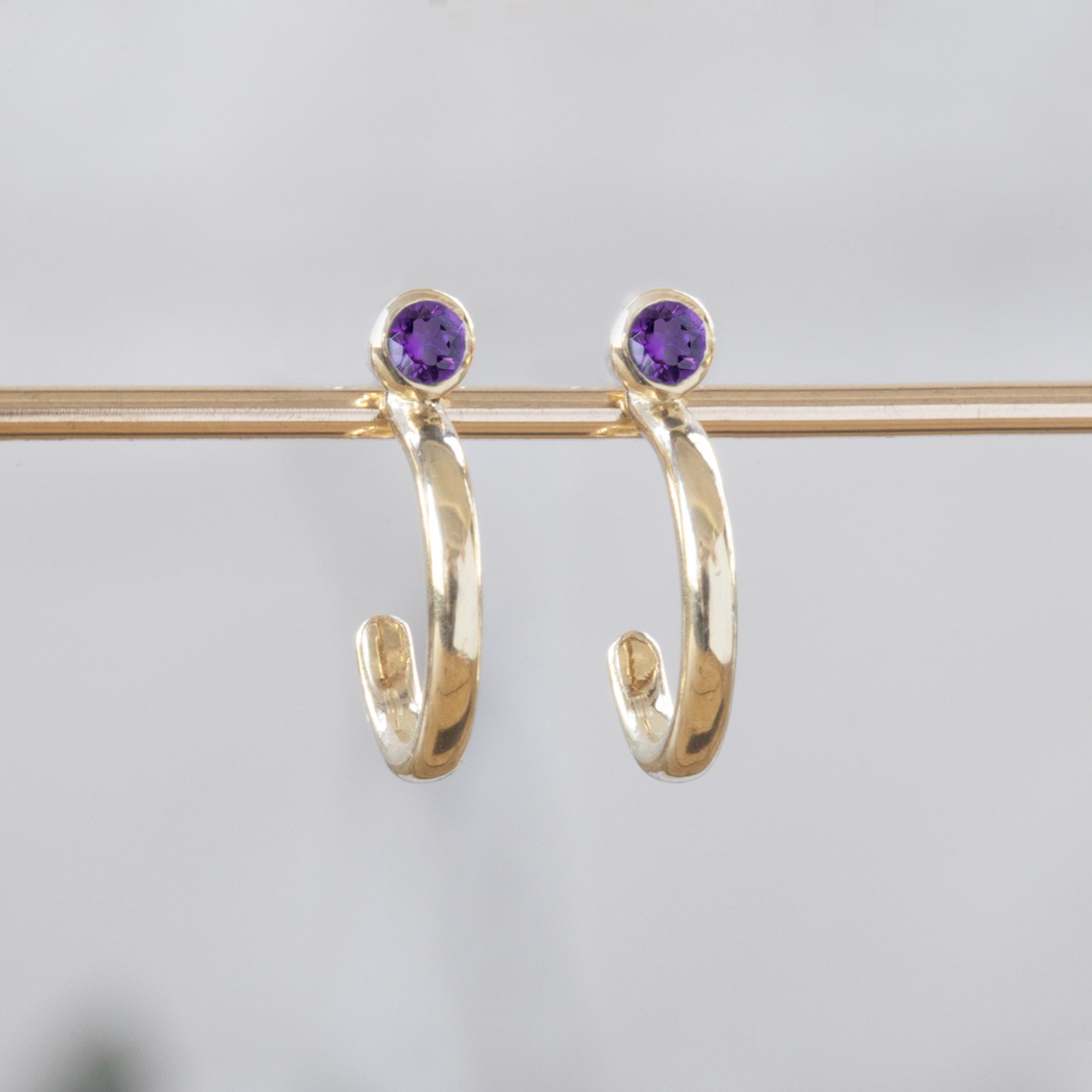 Custom Amethyst Birthstone Hoop Earrings | 14K Yellow Gold.
Displayed on bar 