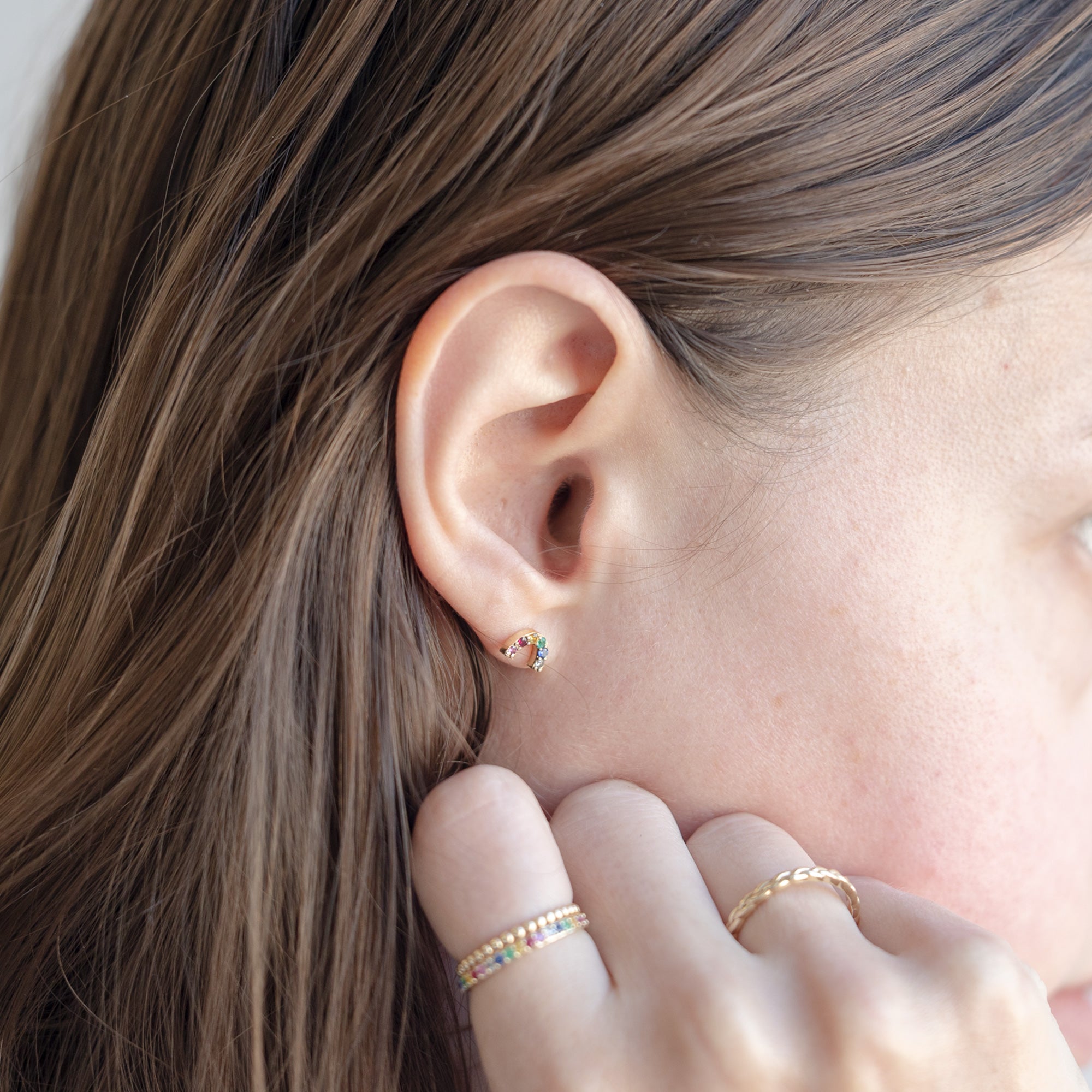 The Rainbow Sapphire Stud Earrings in 14K Yellow Gold on Model