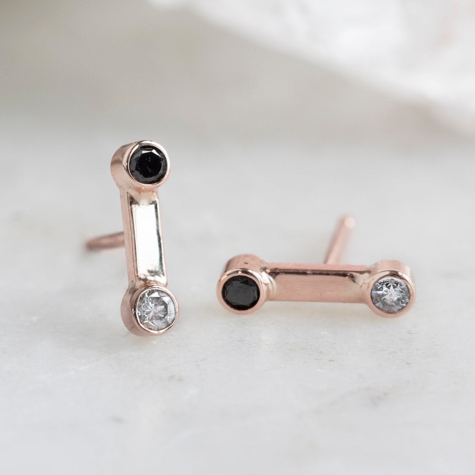 The Duality Diamond Stud Earrings in 14K Rose Gold on White Marble