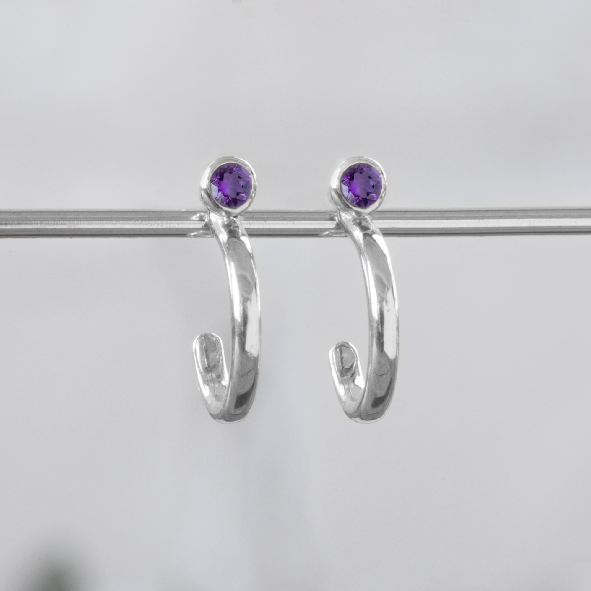 Custom Amethyst Birthstone Hoop Earrings | 14K White Gold 
displayed on bar