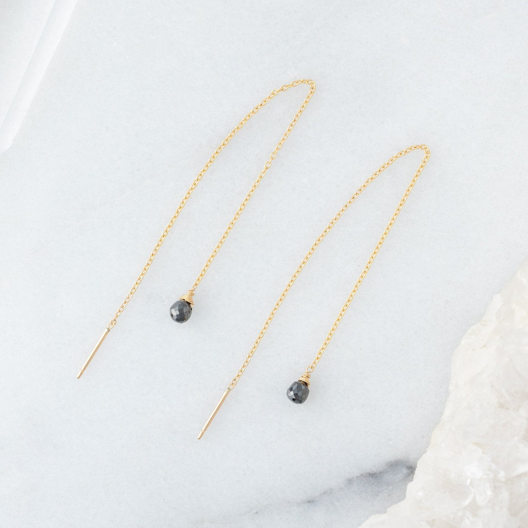 The Simple Black Diamond Drop Thread Earrings in Yellow Gold Filled on White Marble