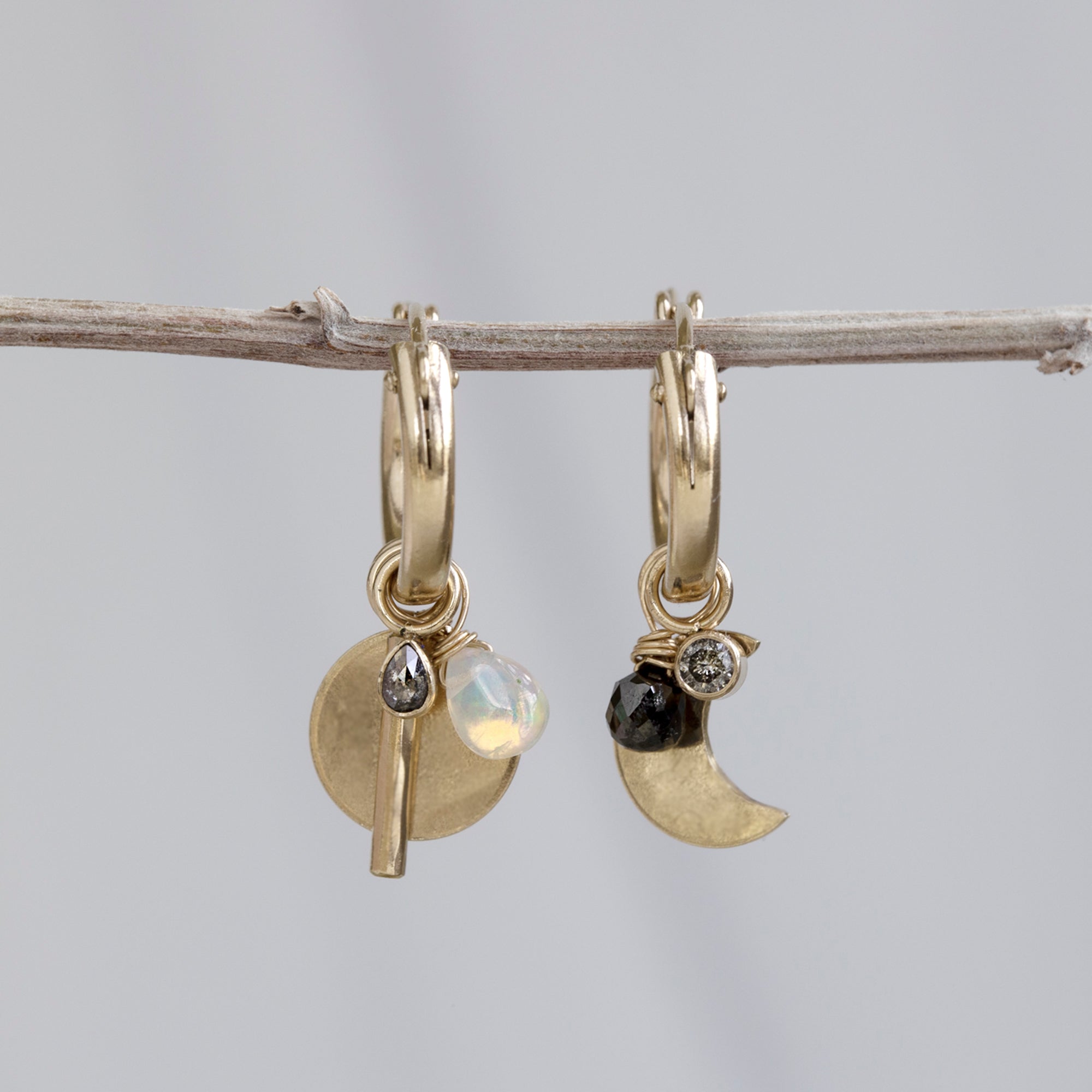 Custom Charm Hoop Earrings | Yellow Gold Filled displayed on holding bar with grey background. 