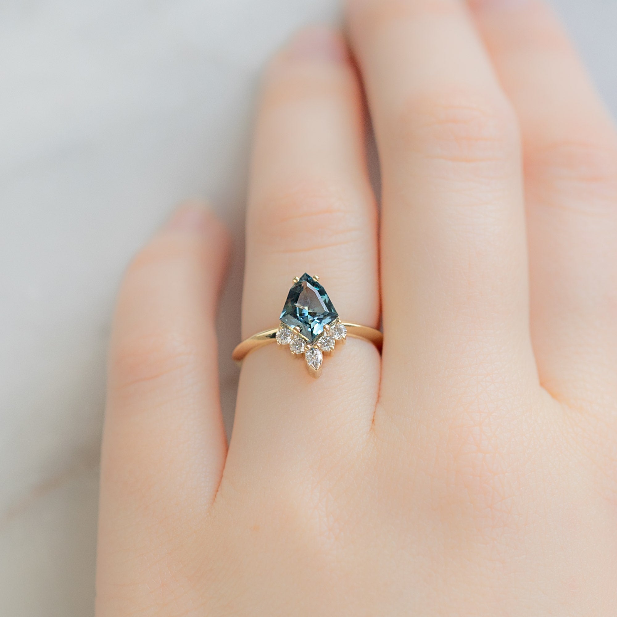 The Aster Ring with a 1.28ct Kite Blue Sapphire in 14K Yellow Gold on Model