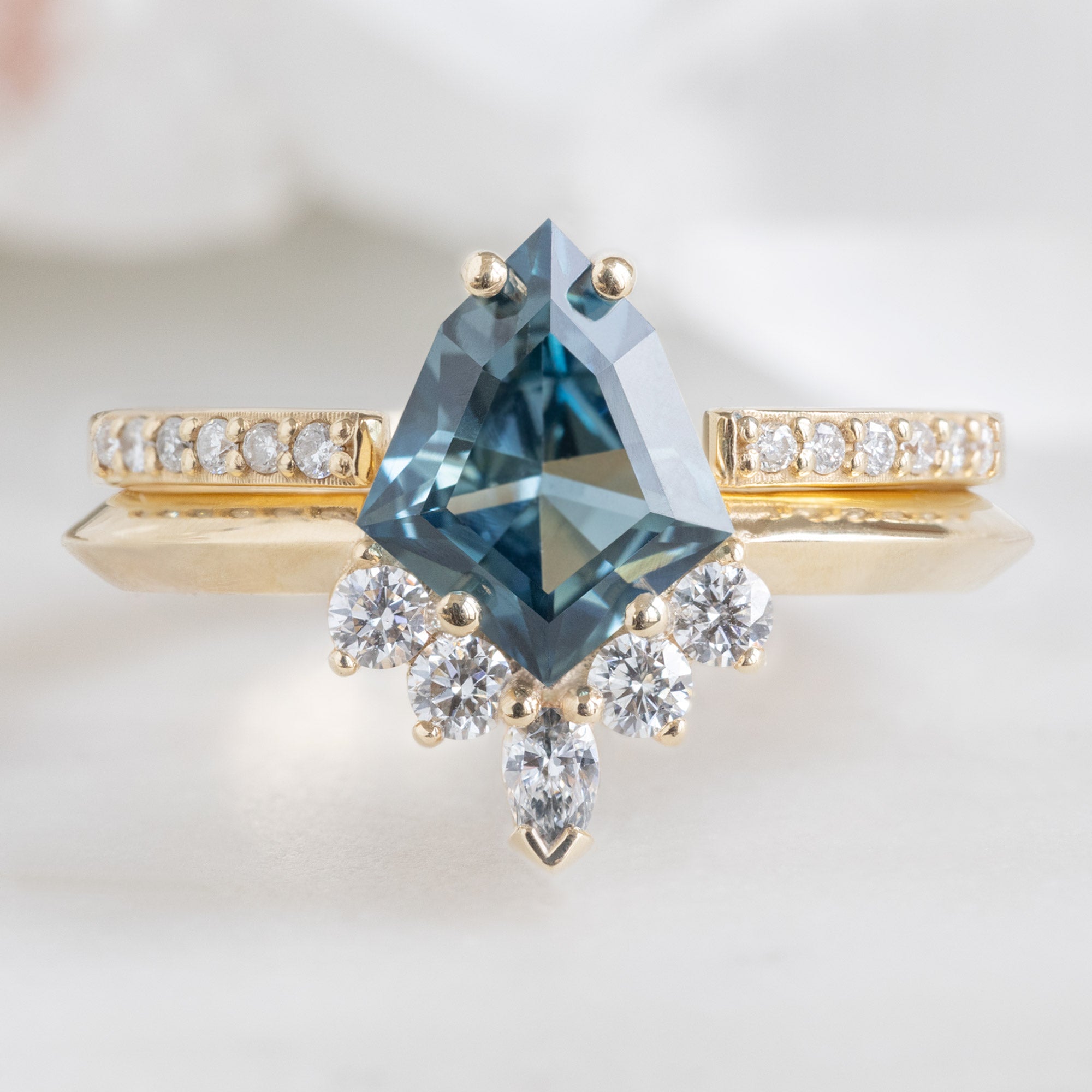 The Aster Ring with a 1.28ct Kite Blue Sapphire in 14K Yellow Gold Stacked with Open Cuff Pavé Diamond Stacking Band