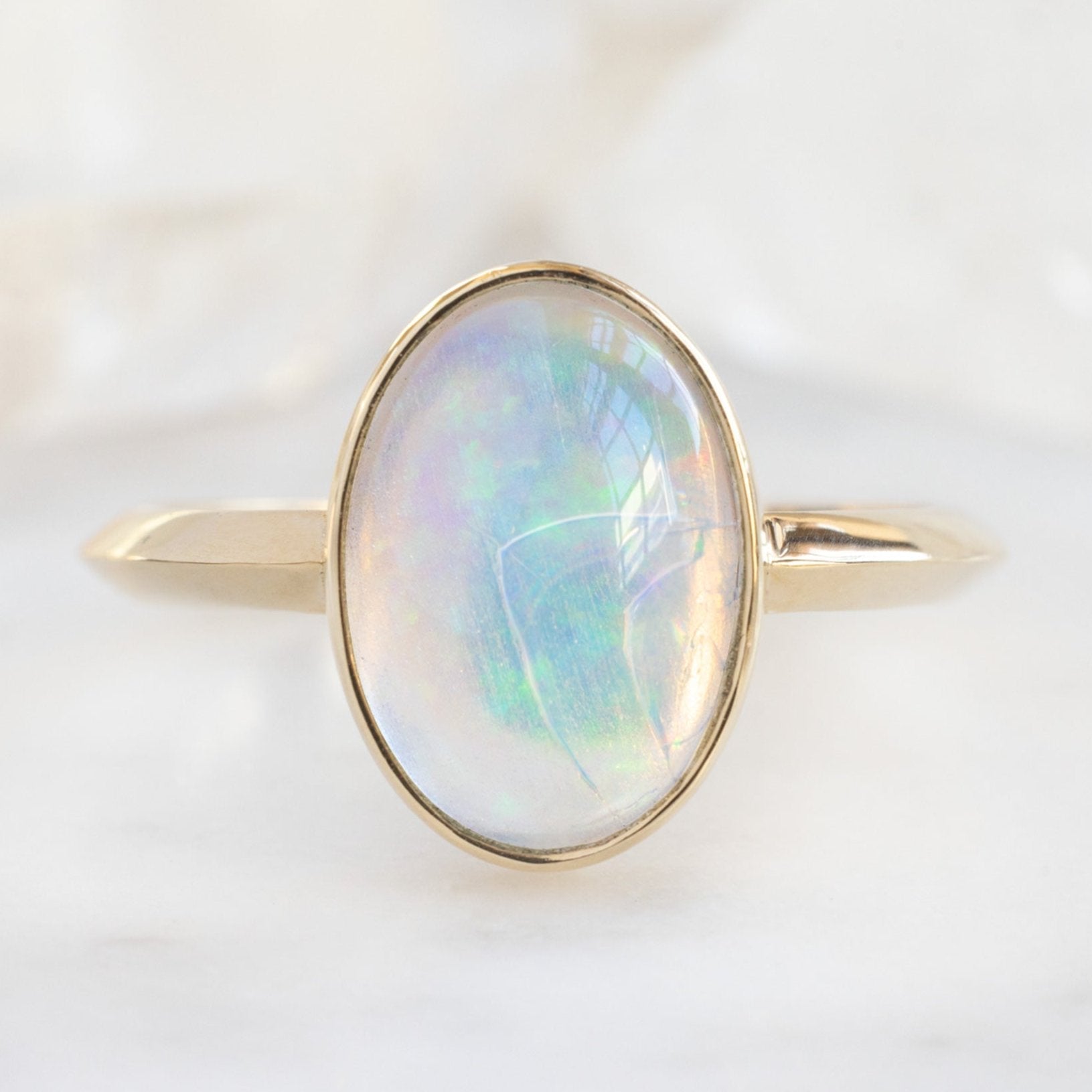 The Hazel Ring with a 1.97ct Oval Opal in 14K Yellow Gold on white background