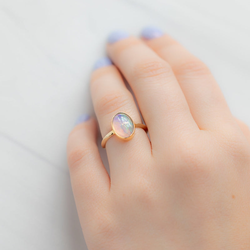 The Hazel Ring with a 1.97ct Oval Opal in 14K Yellow Gold on model