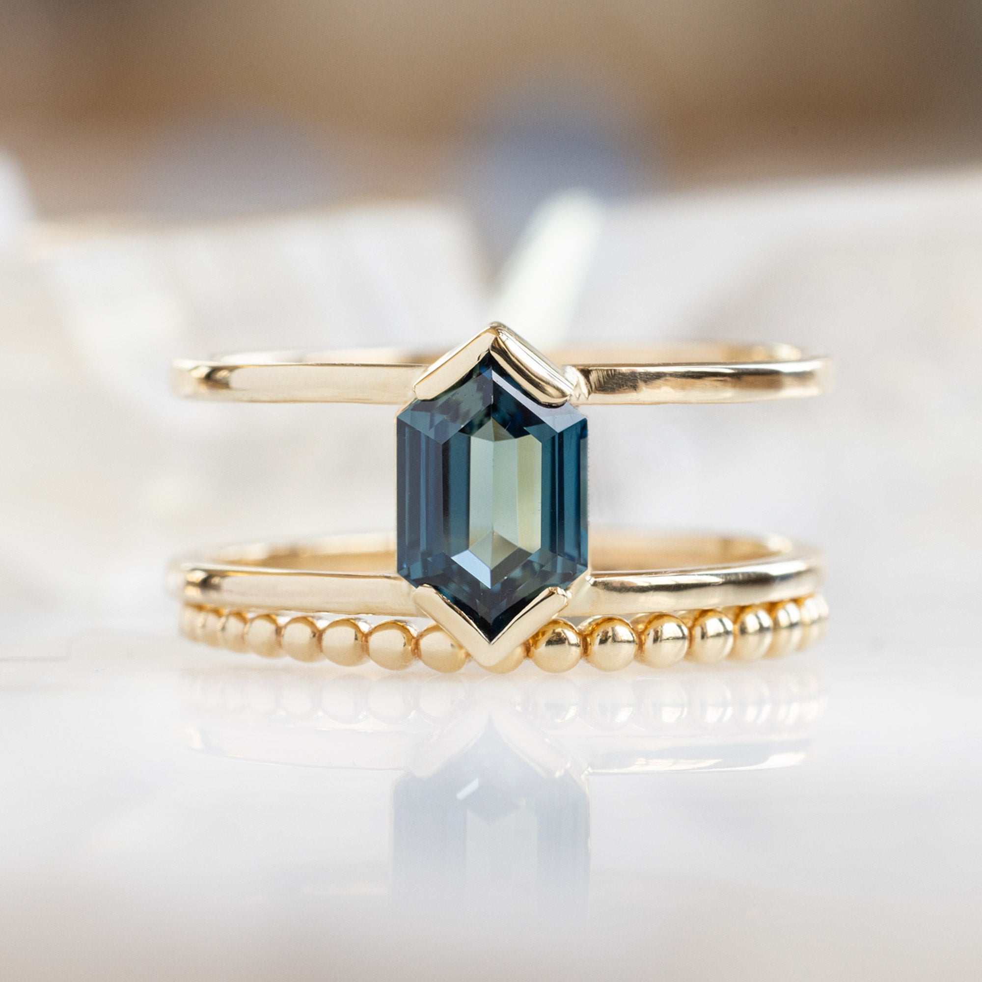 buy:the-poppy-ring-1-24ct-hexagon-blue-sapphire-in-14k-yellow-gold,the-gold-beaded-stacking-ring-14k-yellow-gold