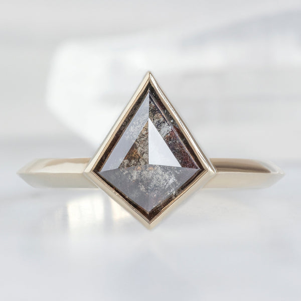 The Hazel Ring with a 1.31ct Kite Black Diamond in 14K Yellow Gold on White Marble