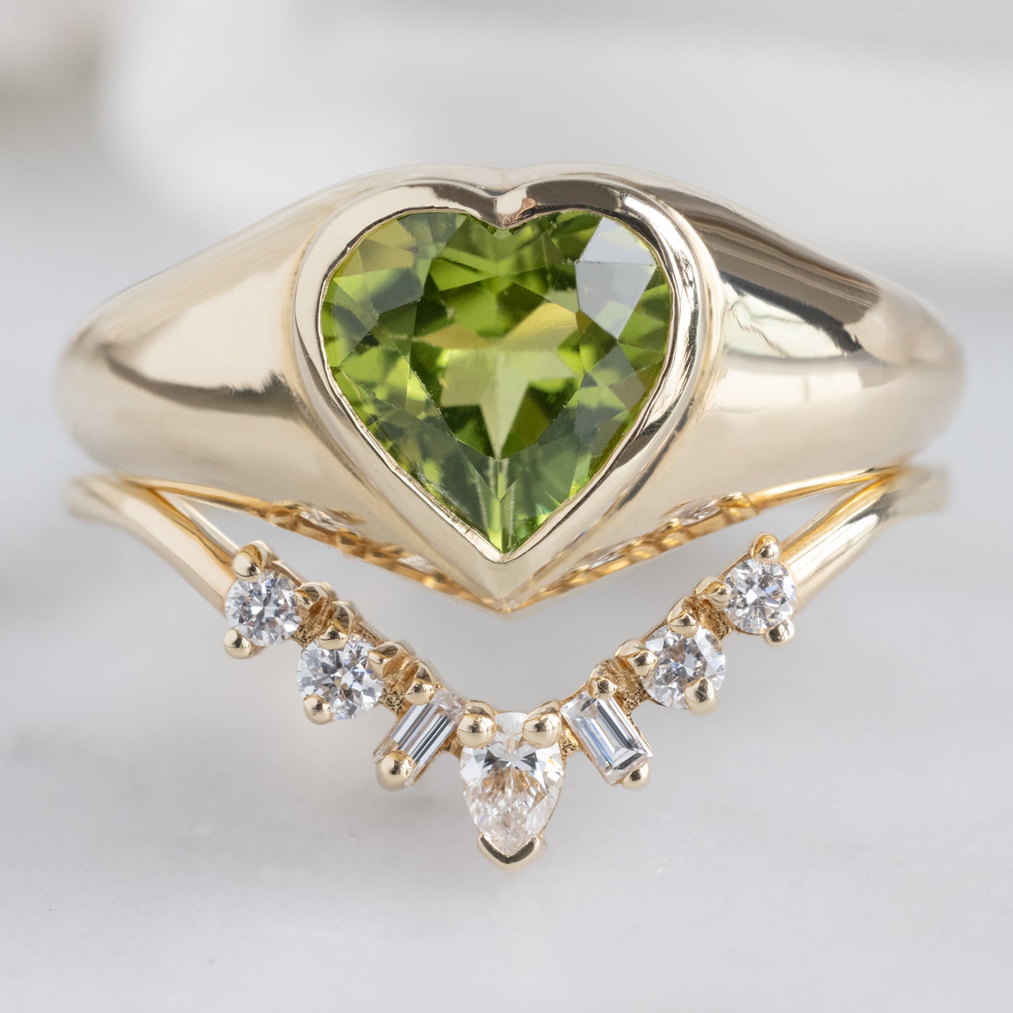 The Signet Ring with a 1.39ct Heart Peridot in 14K Yellow Gold Stacked with the Geometric Sunburst Diamond Stacking Band