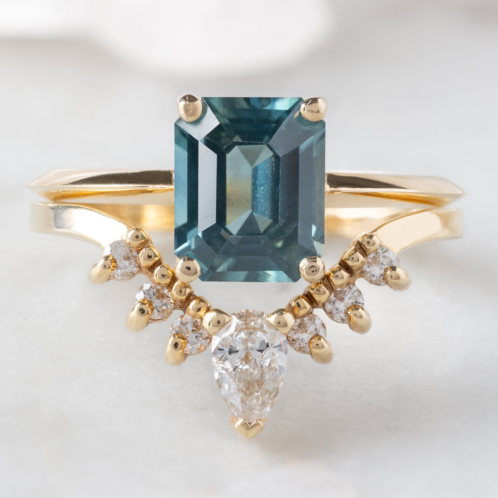 buy:the-bryn-ring-1-78ct-emerald-cut-sapphire-in-14k-yellow-gold,white-pear-diamond-sunburst-stacking-band-14k-gold