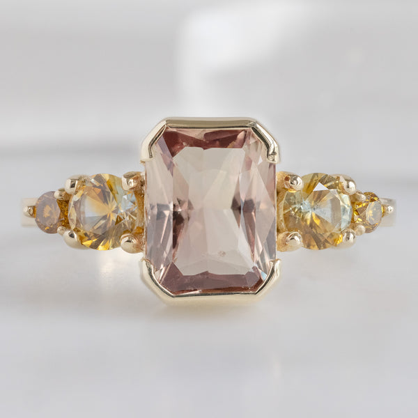 The Watercolor Ring in 2.04ct Emerald Cut Peach Sapphire in 14K Yellow Gold on white background