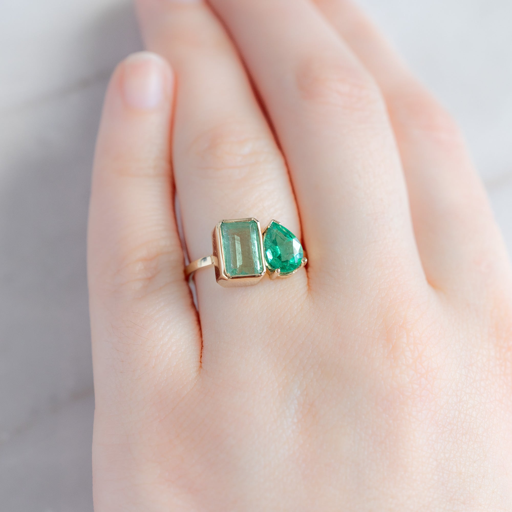 The Watercolor You and Me Ring with a 1.93ct Emerald Cut Emerald in 14K Yellow Gold on model