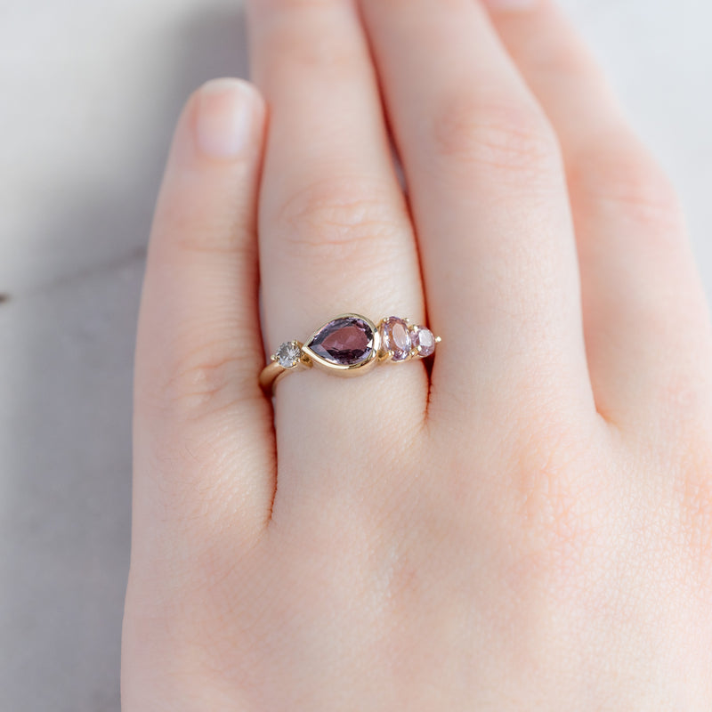 The Watercolor Ring with a 1.27ct Pear Magenta Sapphire in 14K Yellow Gold on Model