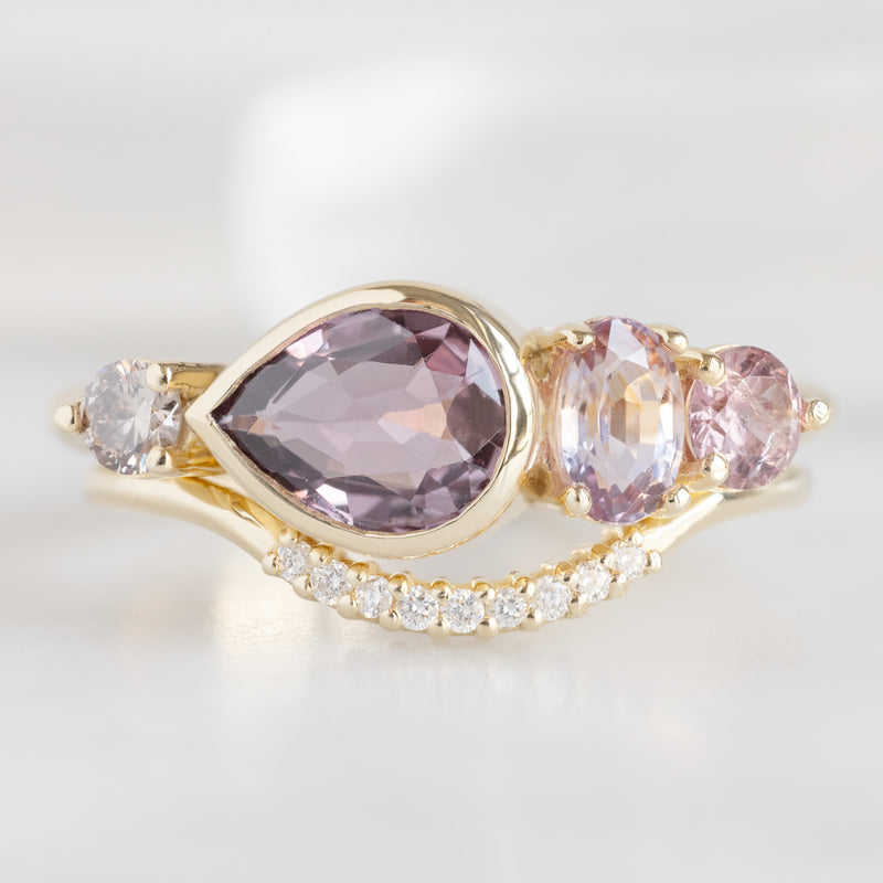 The Watercolor Ring with a 1.27ct Pear Magenta Sapphire in 14K Yellow Gold with White Diamond Pavé Arc Stacking Band