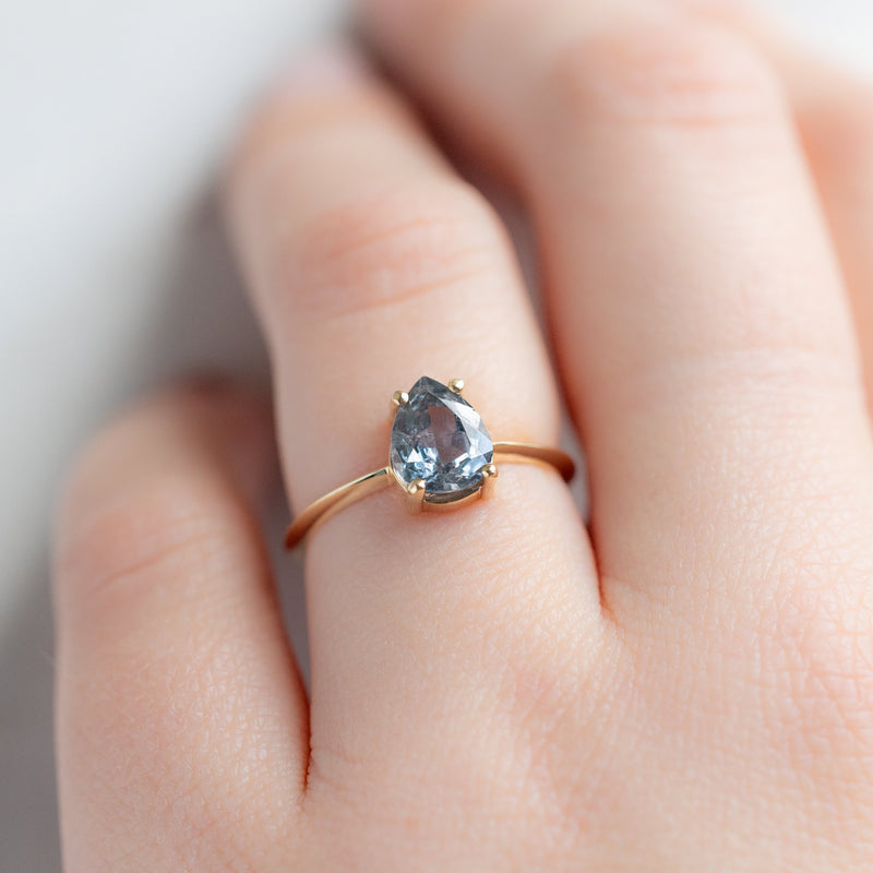 The Bryn Ring with a 1.42ct Pear Cut Blue Sapphire in 14K Yellow Gold on model