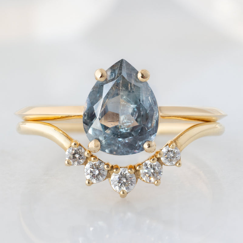 The Bryn Ring with a 1.42ct Pear Cut Blue Sapphire in 14K Yellow Gold with Round Diamond Sunburst Stacking Band