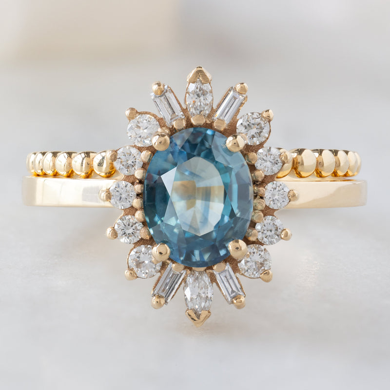 The Camellia Ring with a 1.32ct Oval Blue Montana Sapphire in 14K Yellow  with Beaded Stacking Band