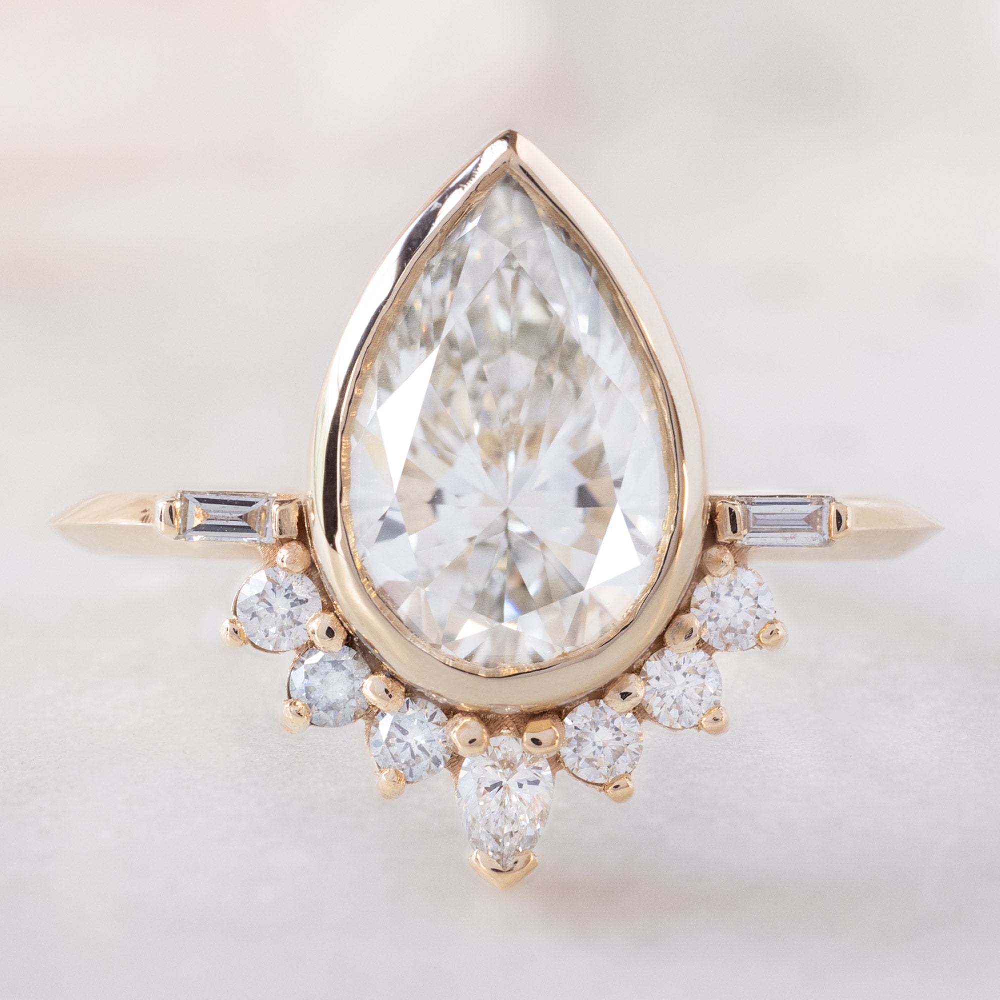 The Posy Ring with a 2.20ct Pear Lab Grown White Diamond in 14K Yellow Gold on White Background