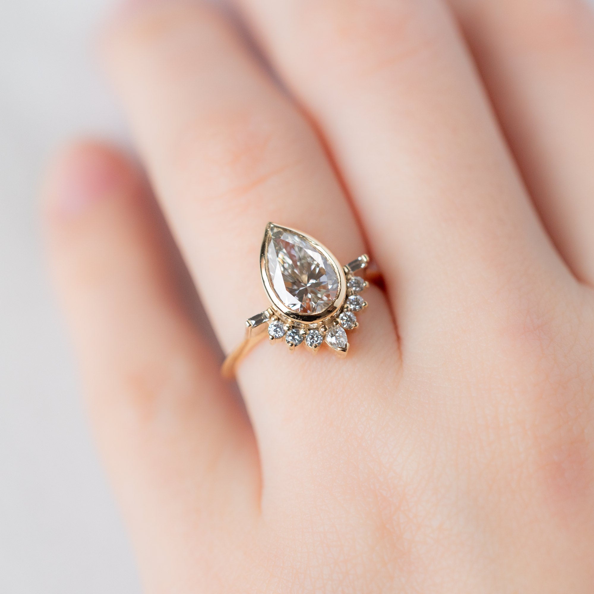 The Posy Ring with a 2.20ct Pear Lab Grown White Diamond in 14K Yellow Gold on Model