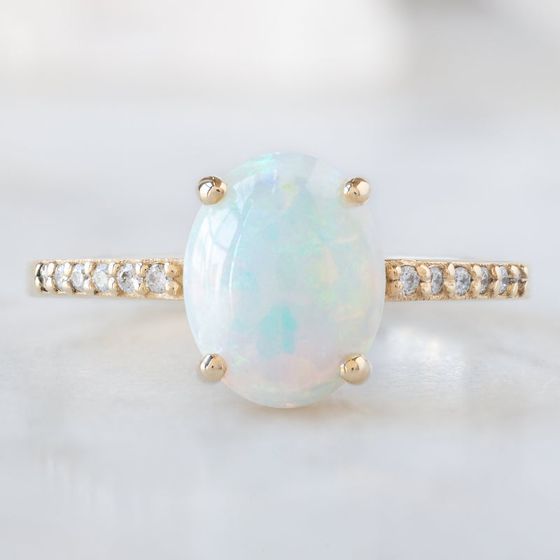 The Willow Ring with a 1.11ct Oval Australian Opal in 14K Yellow Gold on White Marble