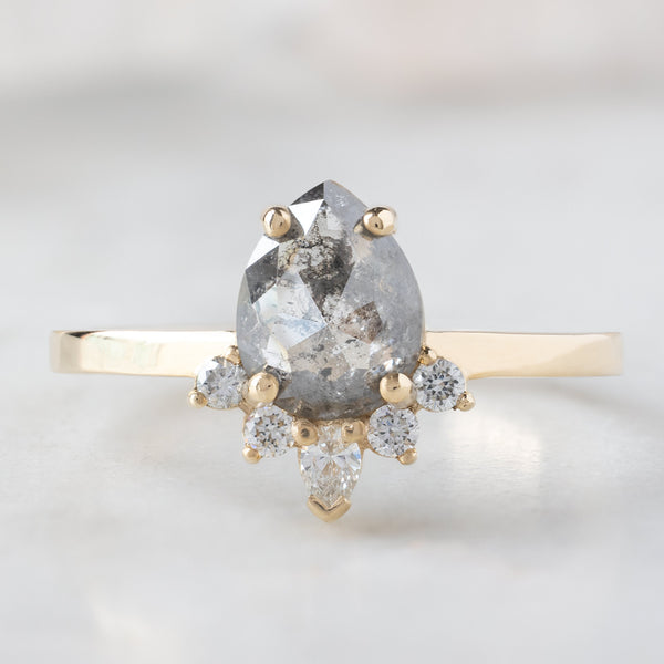 The Aster Ring with a 0.95ct Pear Salt and Pepper Diamond in 14K Yellow Gold on White Marble