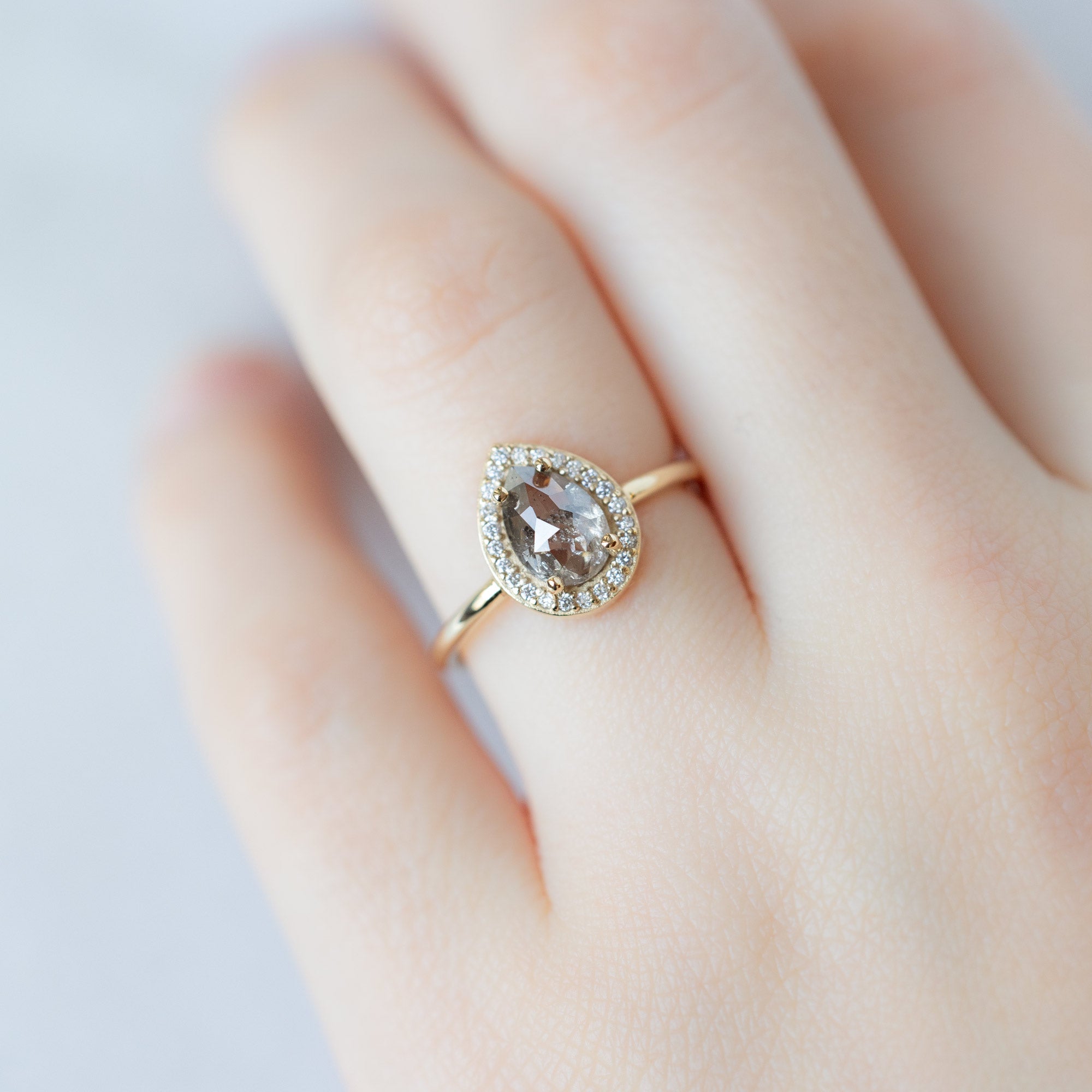 The Dahlia Ring with a 1.12ct Pear Salt and Pepper Diamond in 14K Yellow Gold on Model