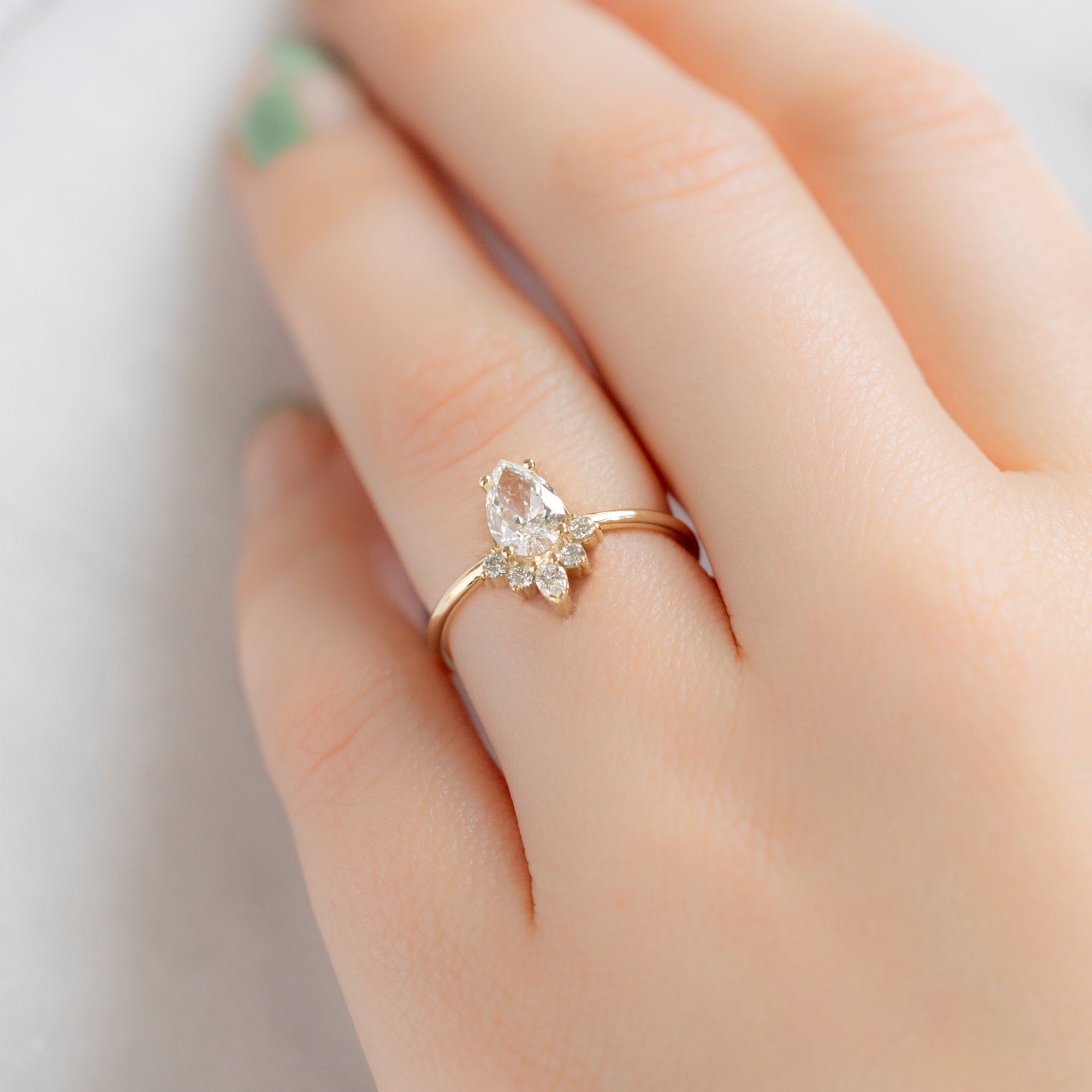 The Aster Ring with a 0.80ct Pear White Diamond in 14K Yellow Gold on Model