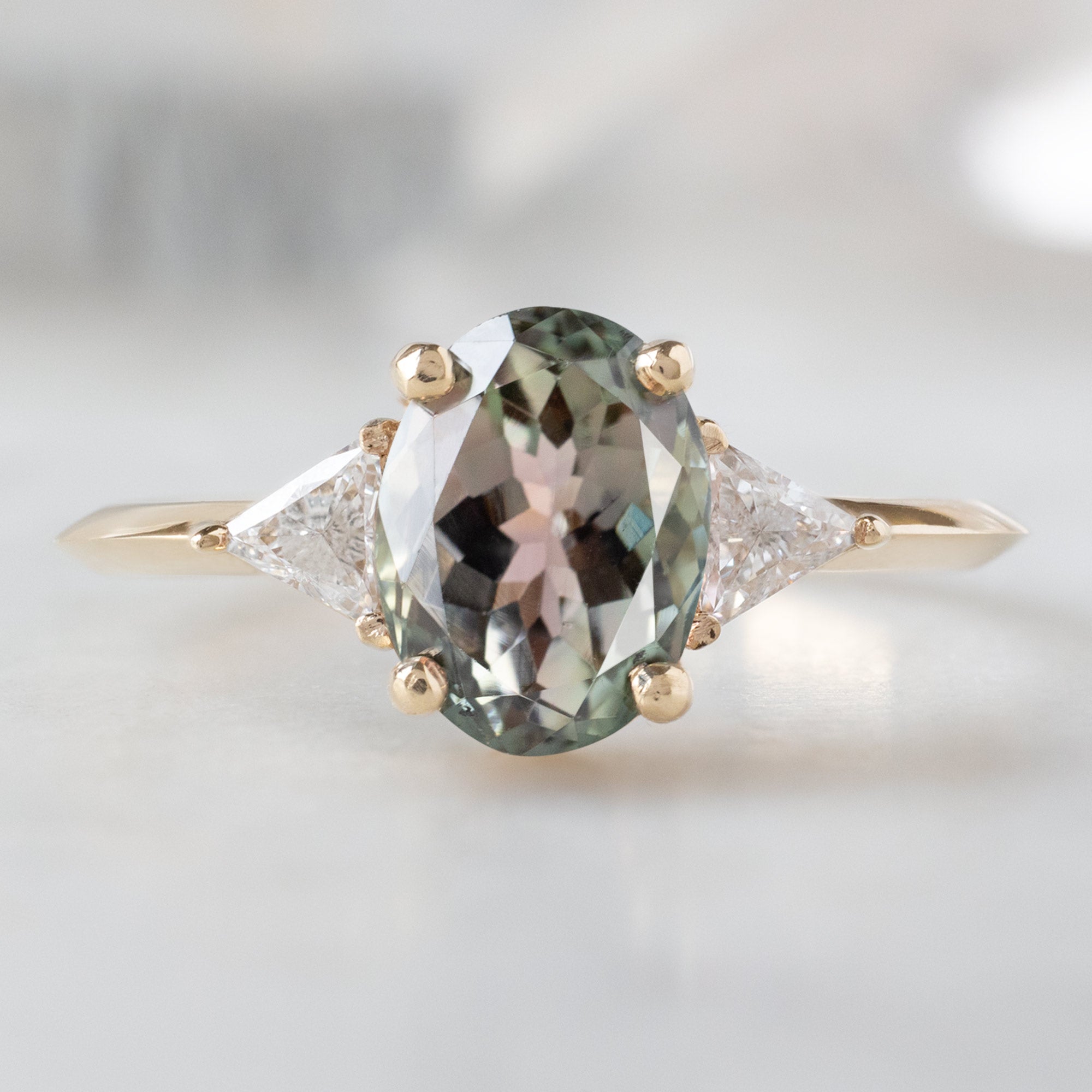 The Jade Ring with a 1.41ct Oval Green Tourmaline in 14K Yellow Gold on White Marble