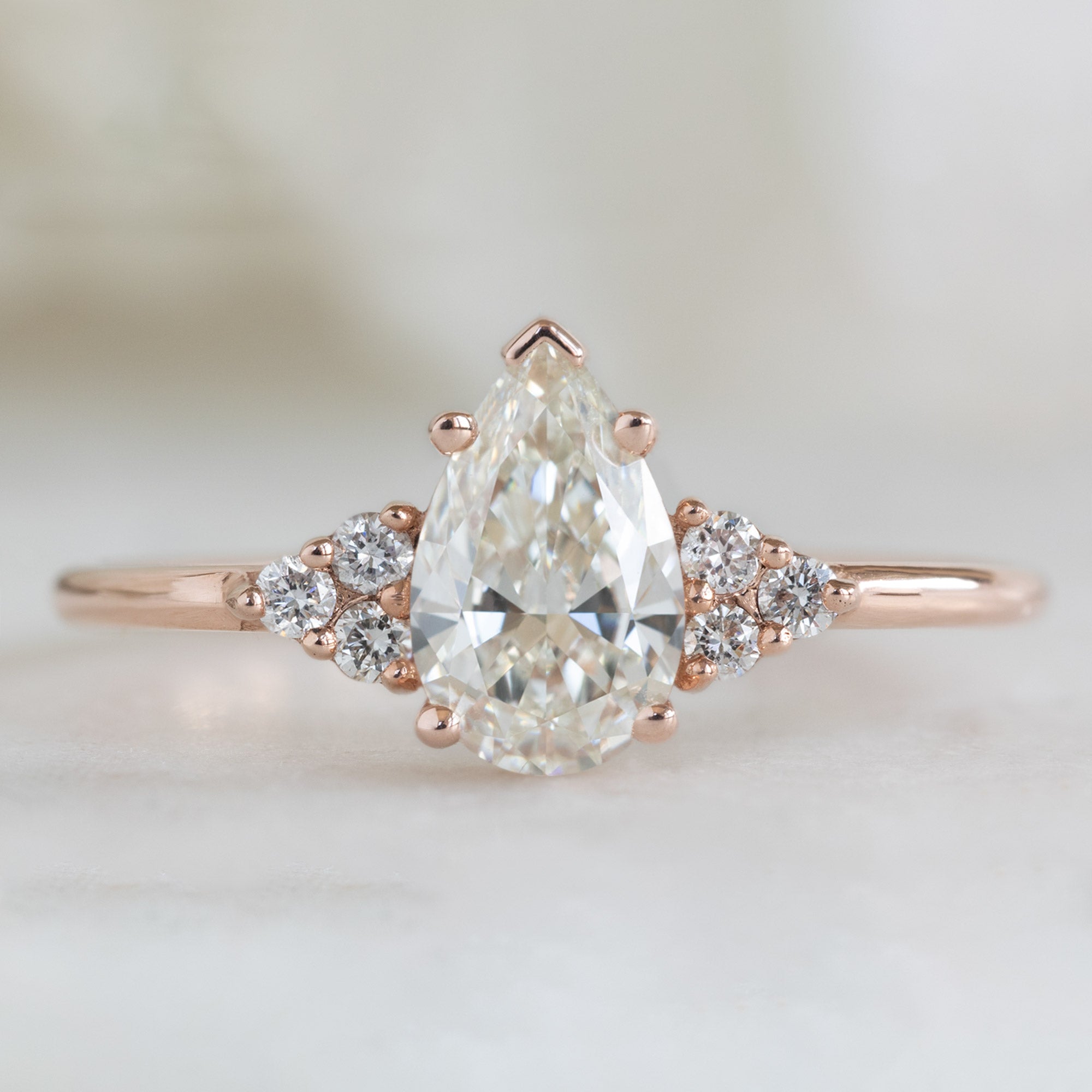 The Ivy Ring with a 0.70ct Pear White Diamond in 14k Rose Gold on White Background