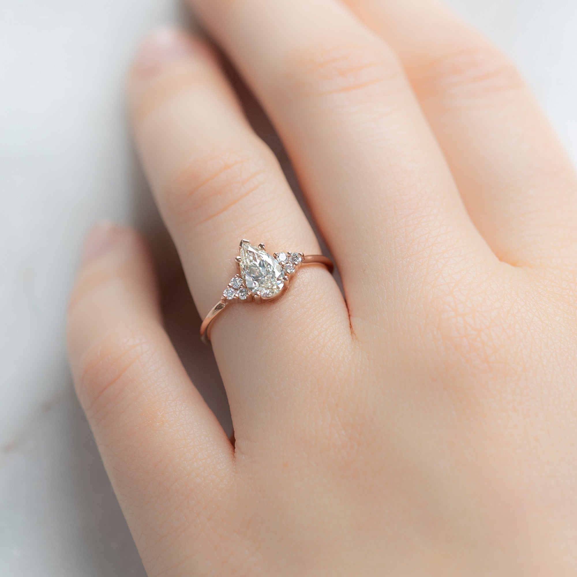 The Ivy Ring with a 0.70ct Pear White Diamond in 14k Rose Gold on Model