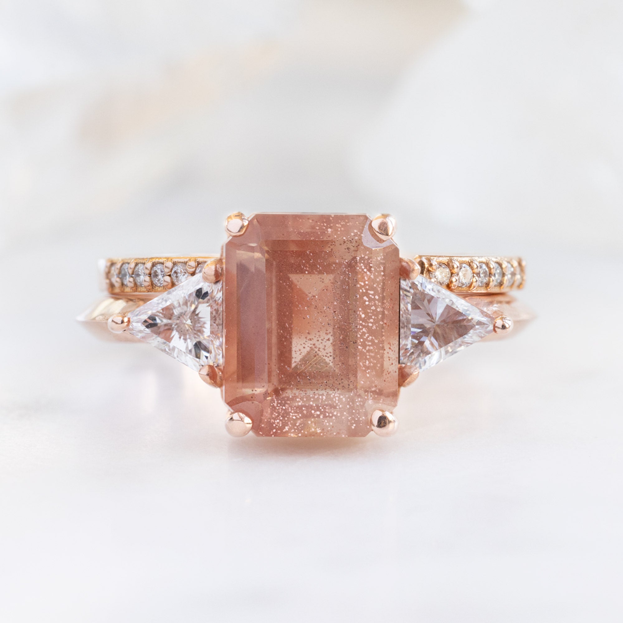 The Jade Ring with a 2.26ct Emerald Cut Sunstone in 14K Rose Gold with Open Cuff Pavé White Diamond Stacking Band on white background