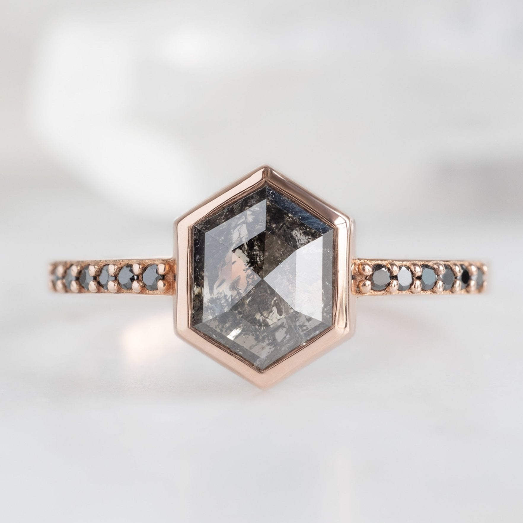 The Willow Ring with a 1.19ct Hexagon Black Diamond in 14K Rose Gold on White Marble