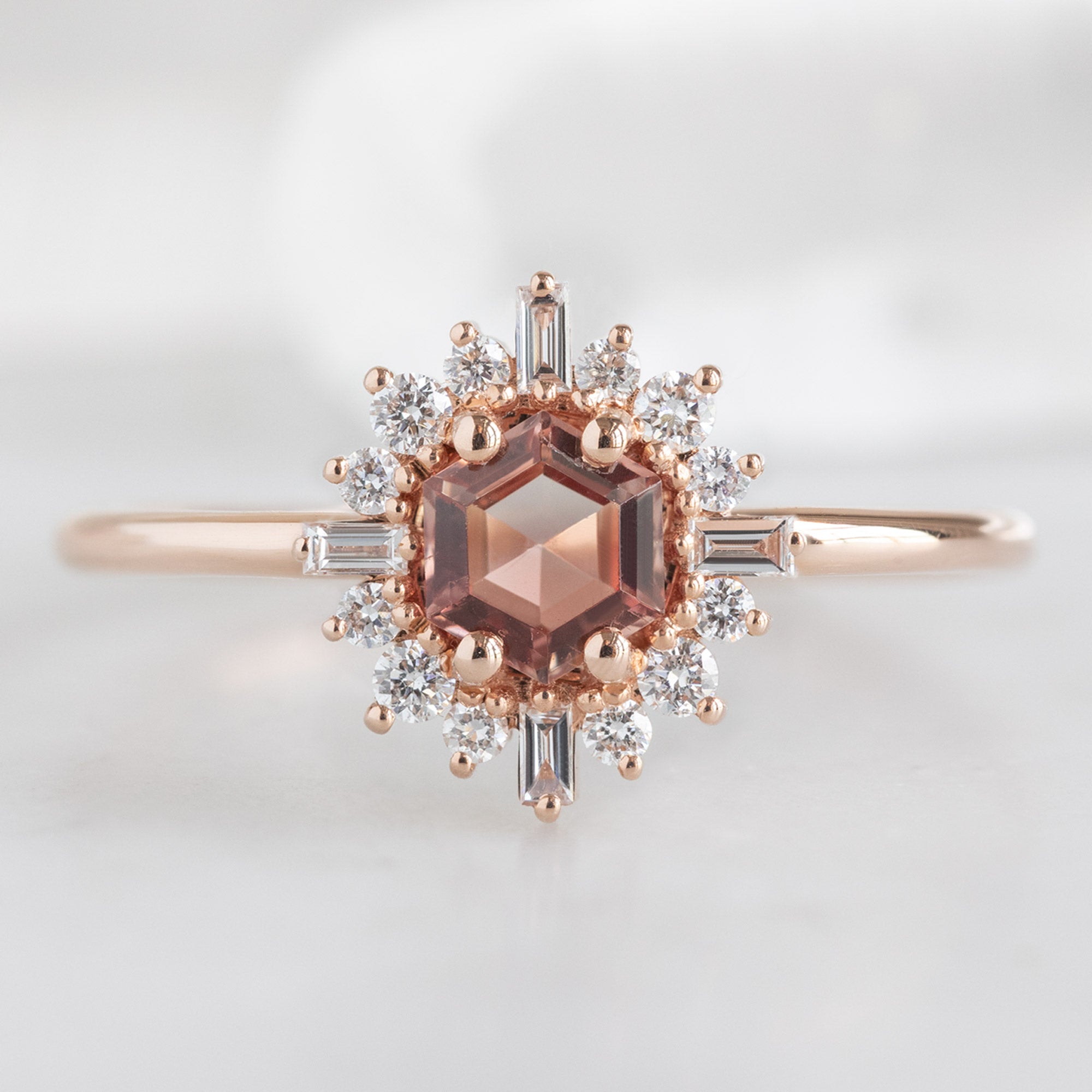 The Compass Ring with a 0.37ct Hexagon Sunstone in 14K Rose Gold on White Marble